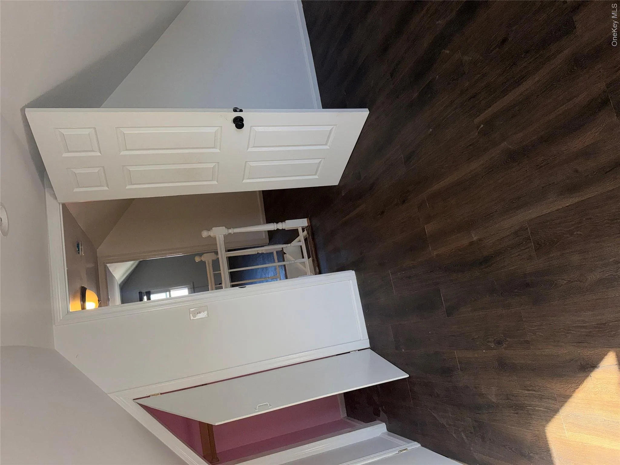 Dark wood-finish flooring with white walls Dark wood-finish flooring with white walls