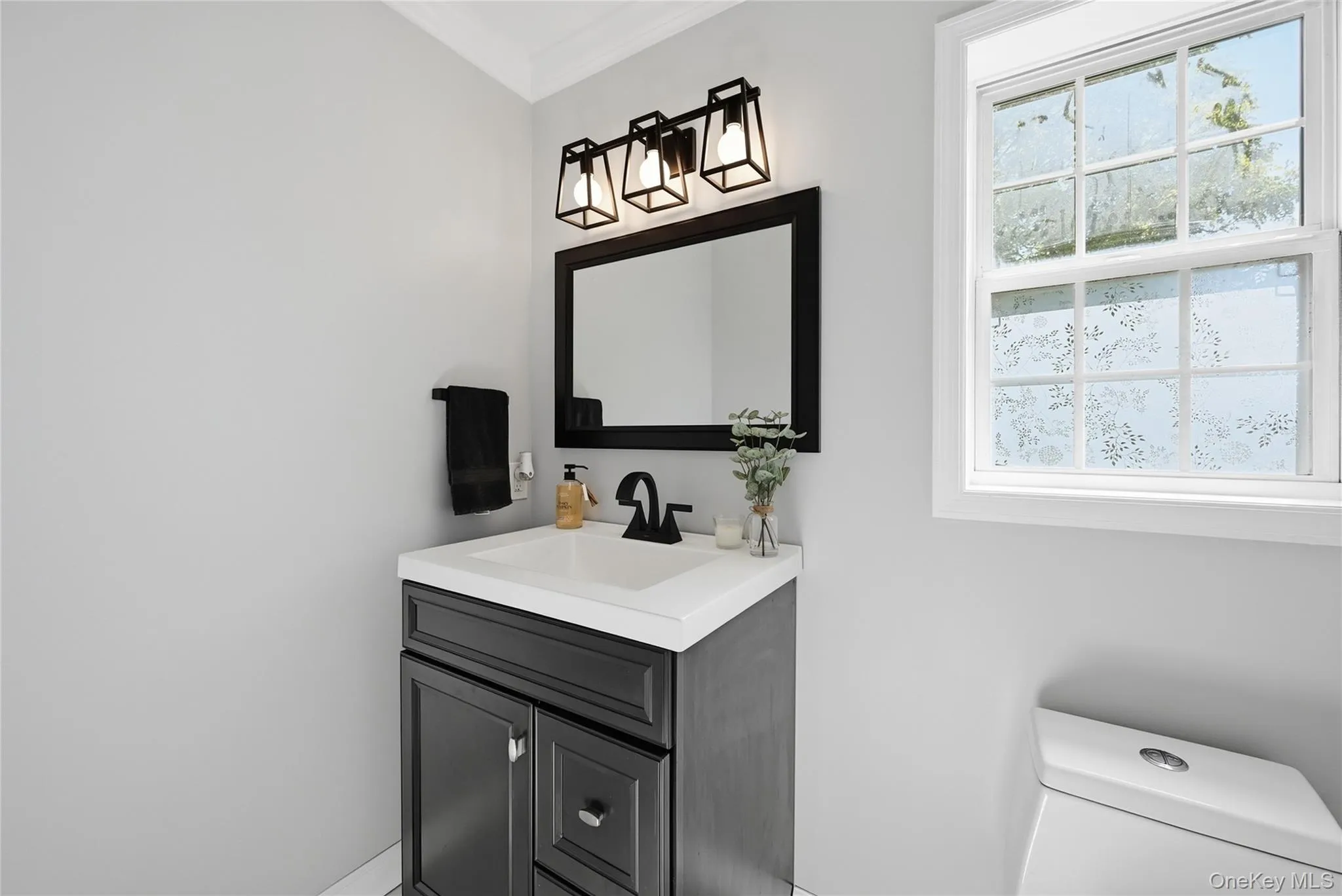 White single-hung window with a patterned privacy film White single-hung window with a patterned privacy film