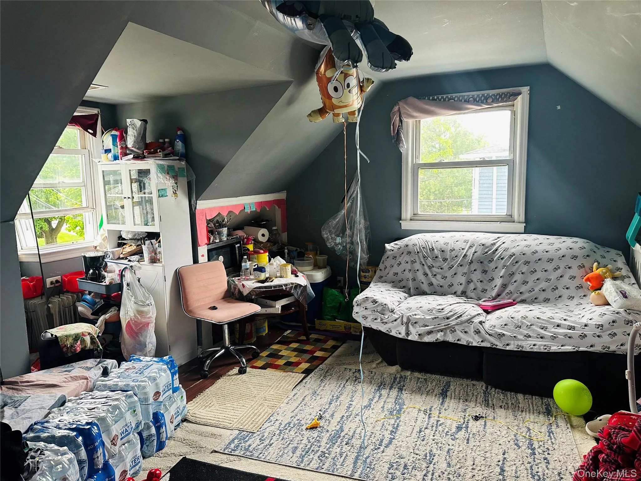 Bedroom with wood finished floors and lofted ceiling Bedroom with wood finished floors and lofted ceiling