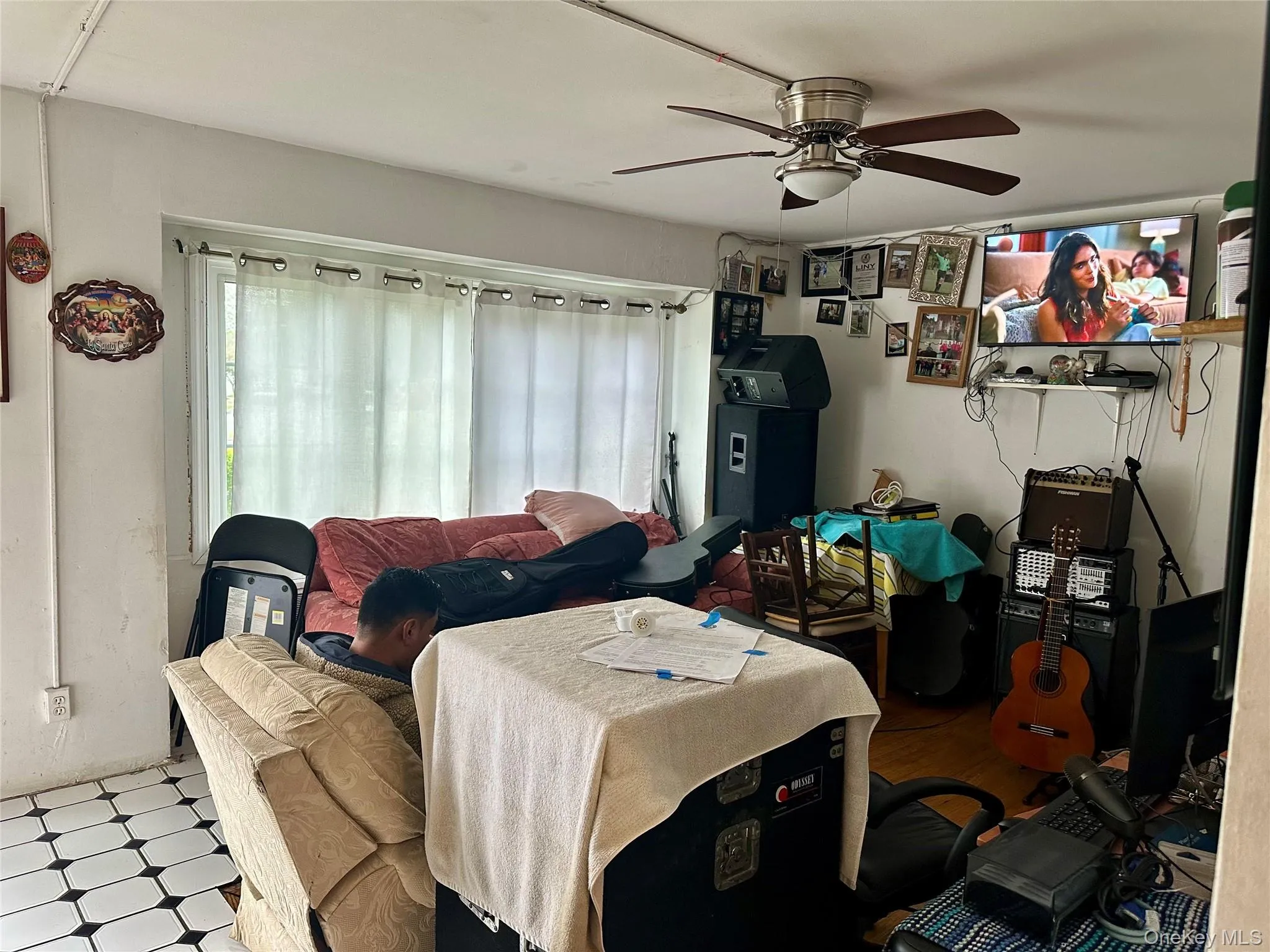 Bedroom with a ceiling fan and tile patterned floors Bedroom with a ceiling fan and tile patterned floors