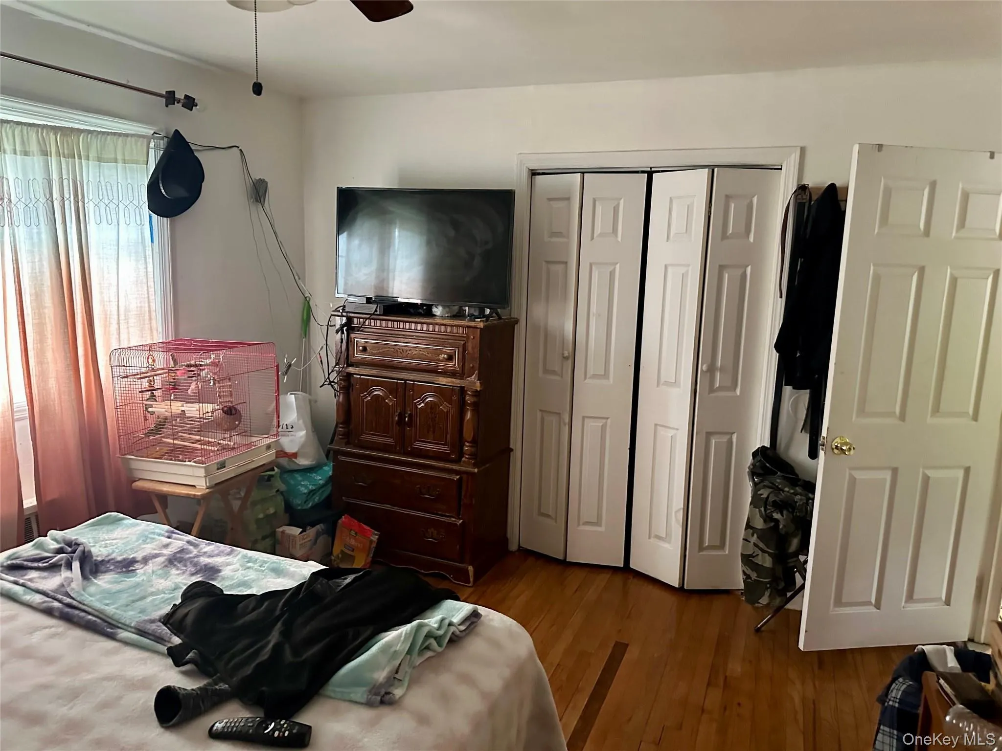 Bedroom featuring a closet, wood finished floors, and ceiling fan Bedroom featuring a closet, wood finished floors, and ceiling fan