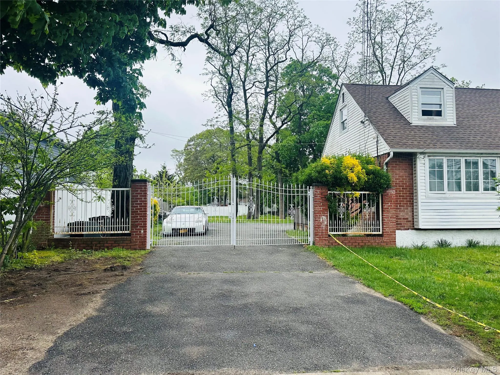 View of street with a gated entry, driveway, and a gate View of street with a gated entry, driveway, and a gate