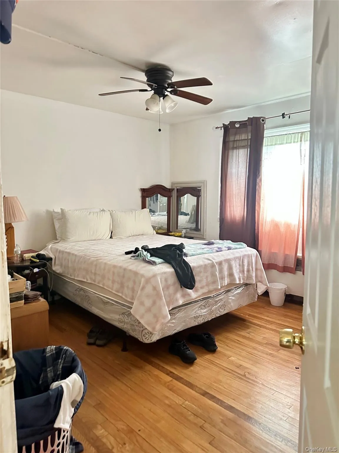 Bedroom featuring ceiling fan and wood-type flooring Bedroom featuring ceiling fan and wood-type flooring