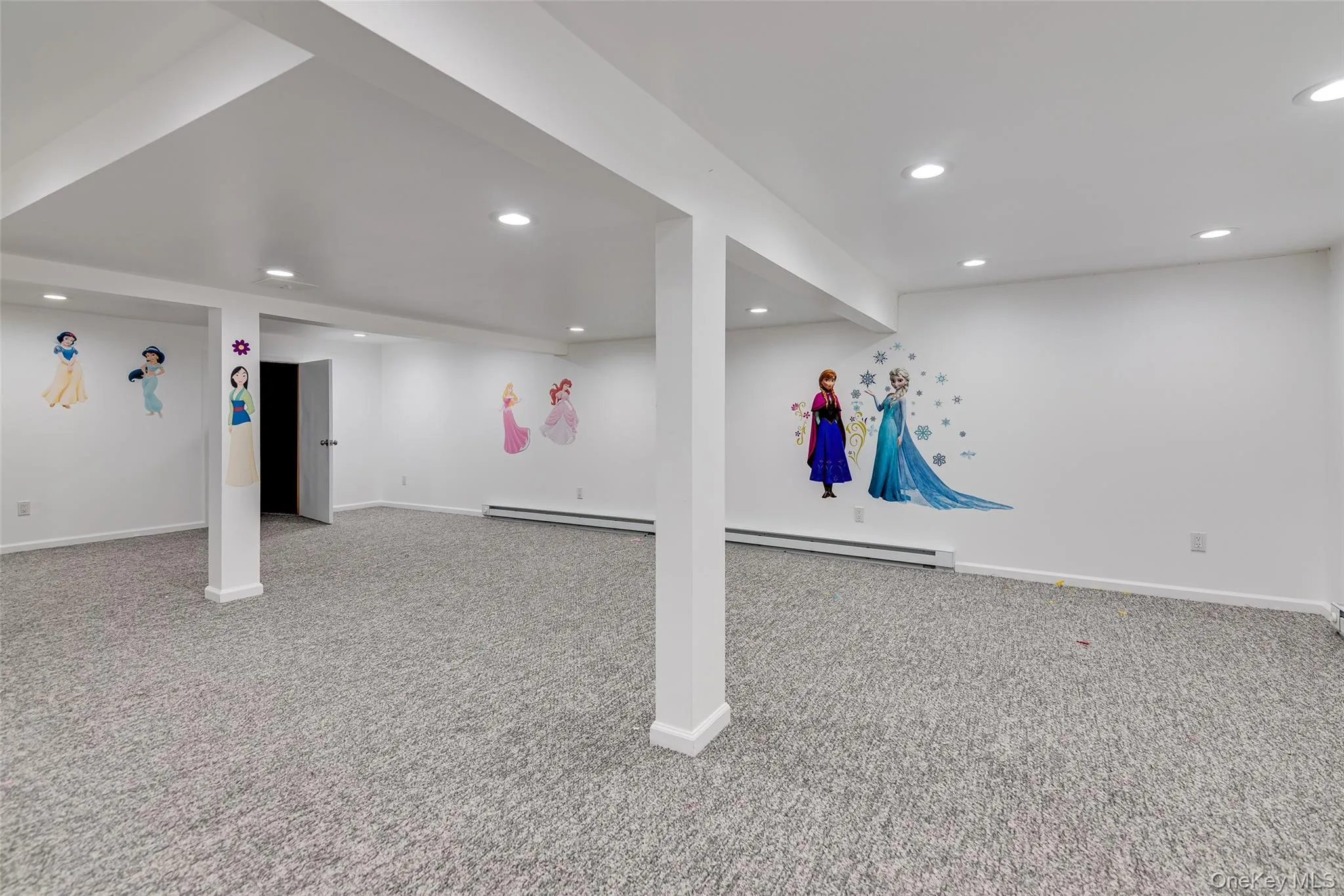 Finished lower level featuring recessed lighting, light gray carpeting, white walls, and exposed support beams Finished lower level featuring recessed lighting, light gray carpeting, white walls, and exposed support beams