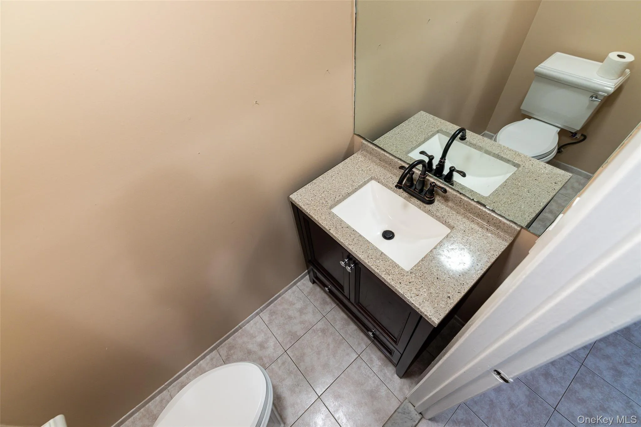 Dark wood-finish vanity with an integrated rectangular sink Dark wood-finish vanity with an integrated rectangular sink