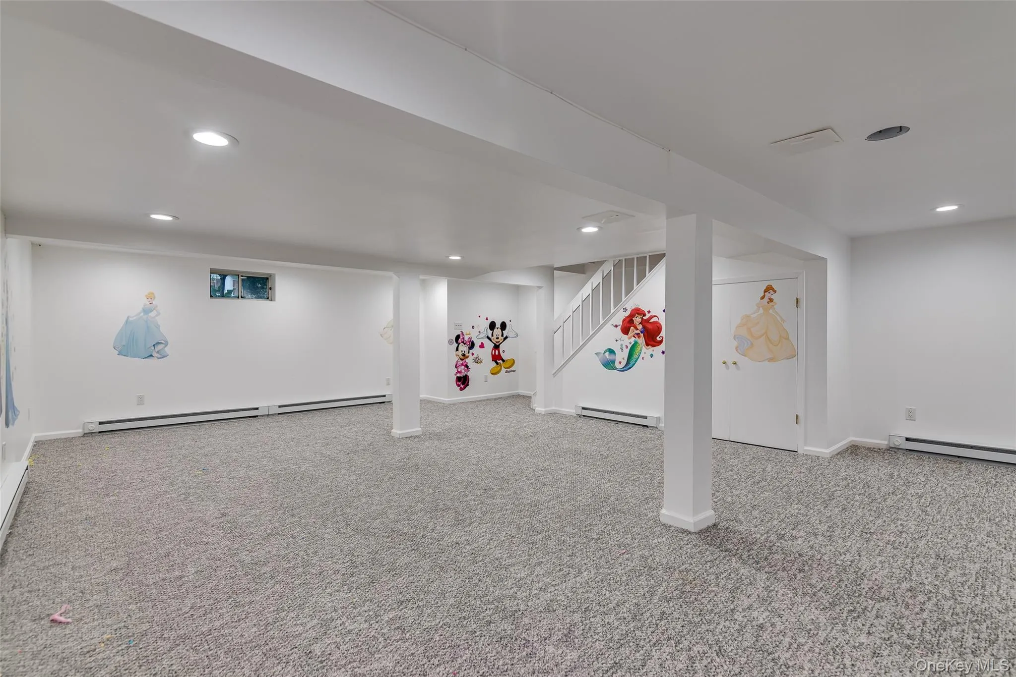 Expansive room featuring light gray carpeting, recessed ceiling lighting, a window, and white painted walls Expansive room featuring light gray carpeting, recessed ceiling lighting, a window, and white painted walls