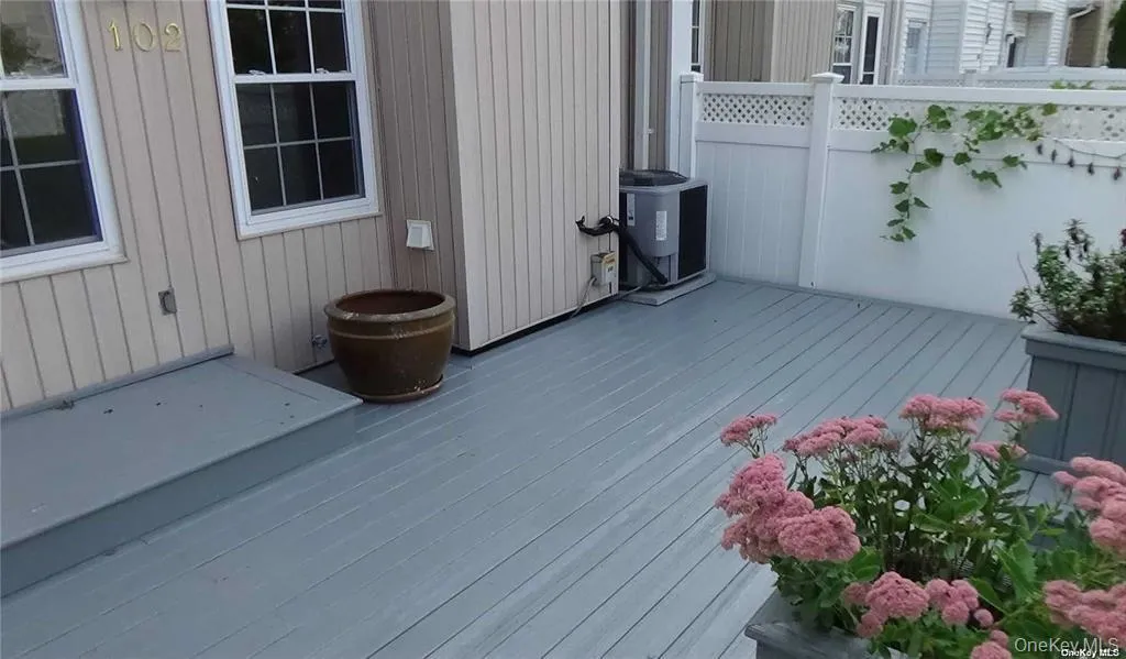 Outdoor decking with a privacy fence, lattice details, and a built-in planter Outdoor decking with a privacy fence, lattice details, and a built-in planter