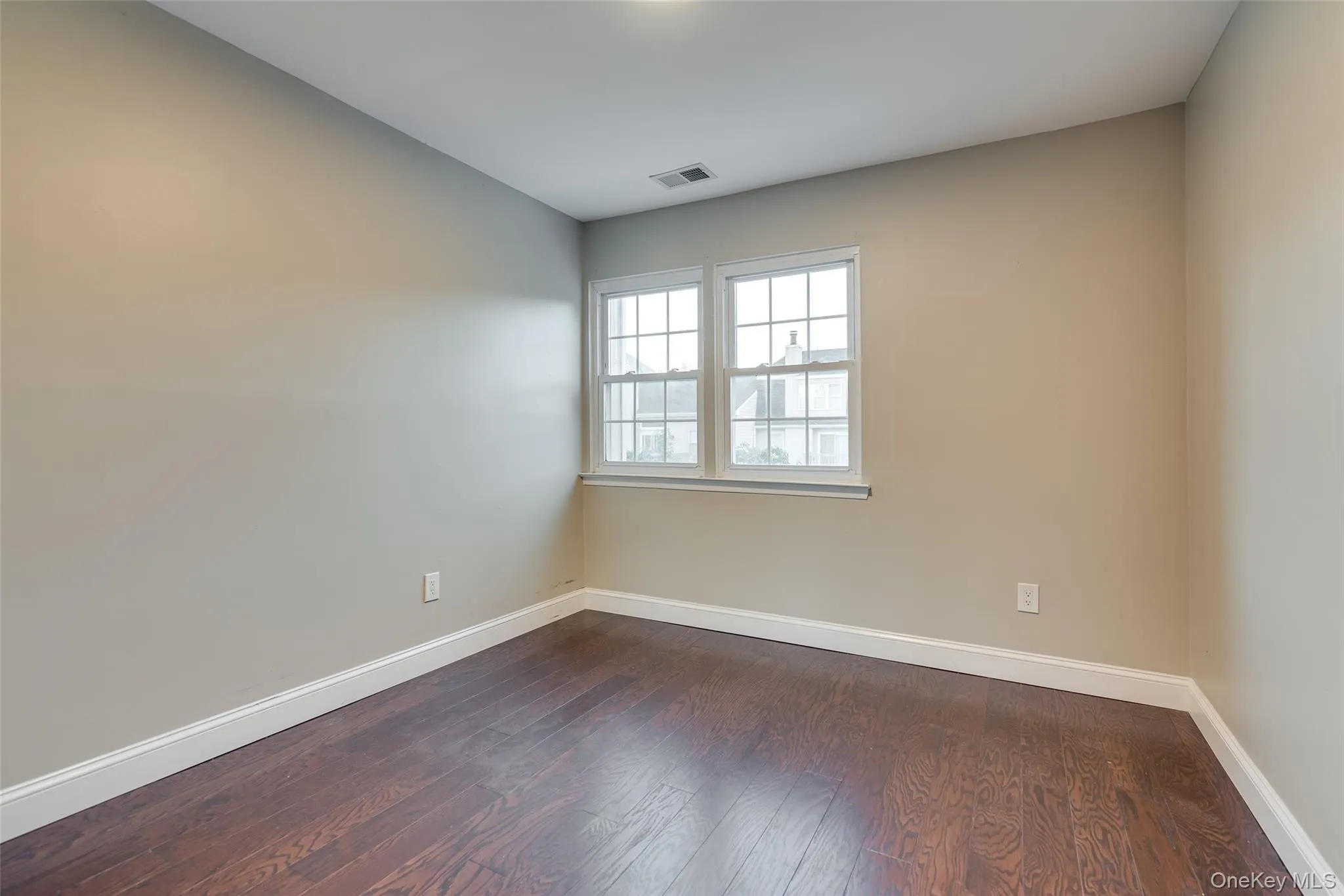 Hardwood-style flooring with white trim, neutral wall tones, and double-paned windows Hardwood-style flooring with white trim, neutral wall tones, and double-paned windows