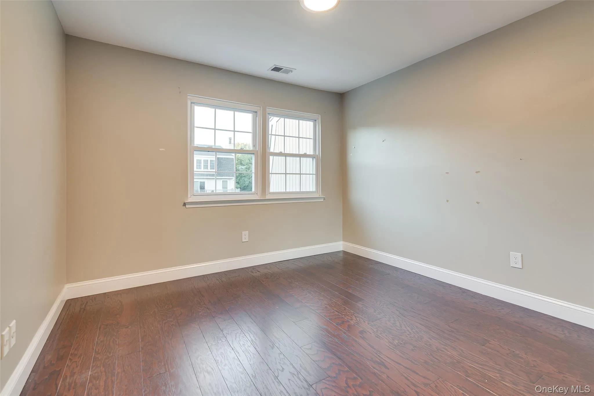 Wood-finish flooring, white window trim, and neutral wall tones Wood-finish flooring, white window trim, and neutral wall tones
