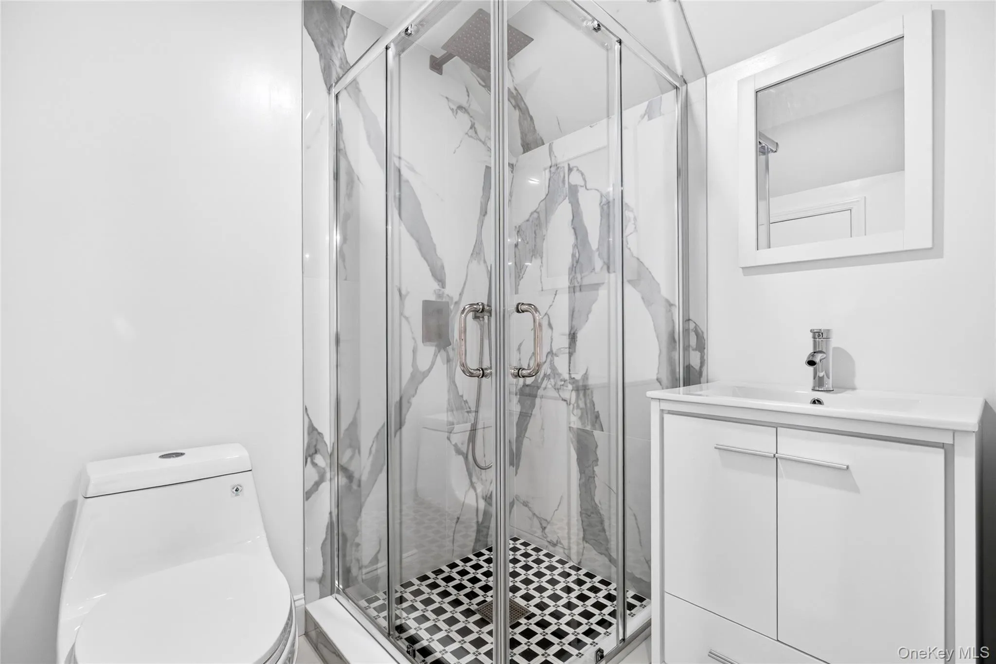 Corner glass-enclosed shower with patterned tile flooring and marble-look wall panels Corner glass-enclosed shower with patterned tile flooring and marble-look wall panels