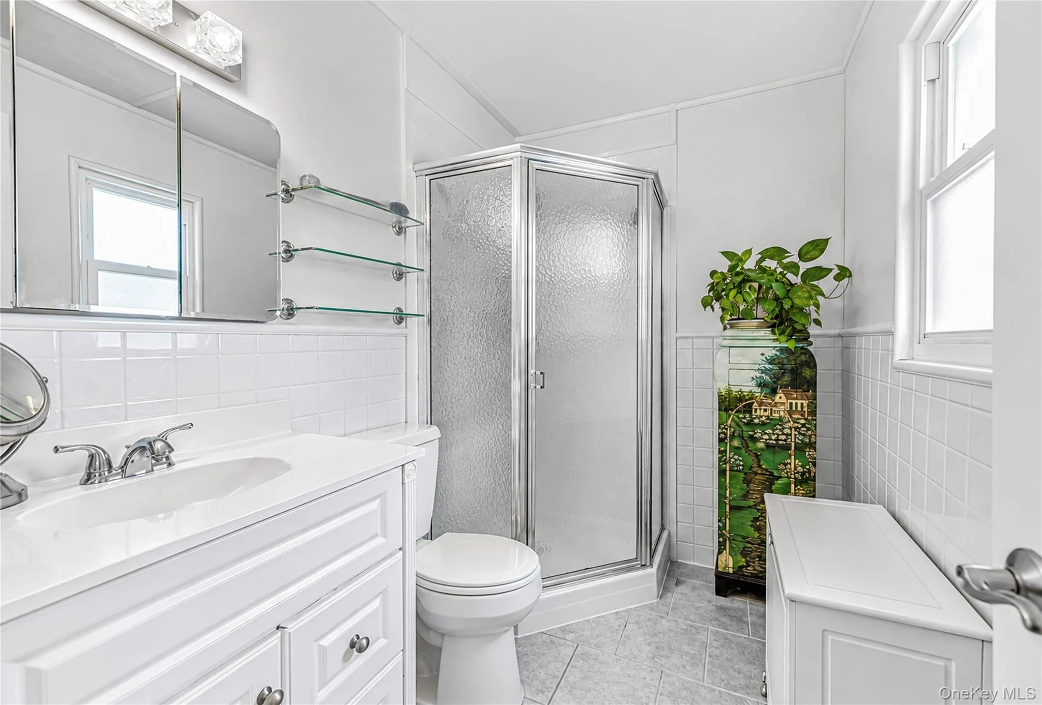 White vanity with integrated sink and chrome faucet White vanity with integrated sink and chrome faucet