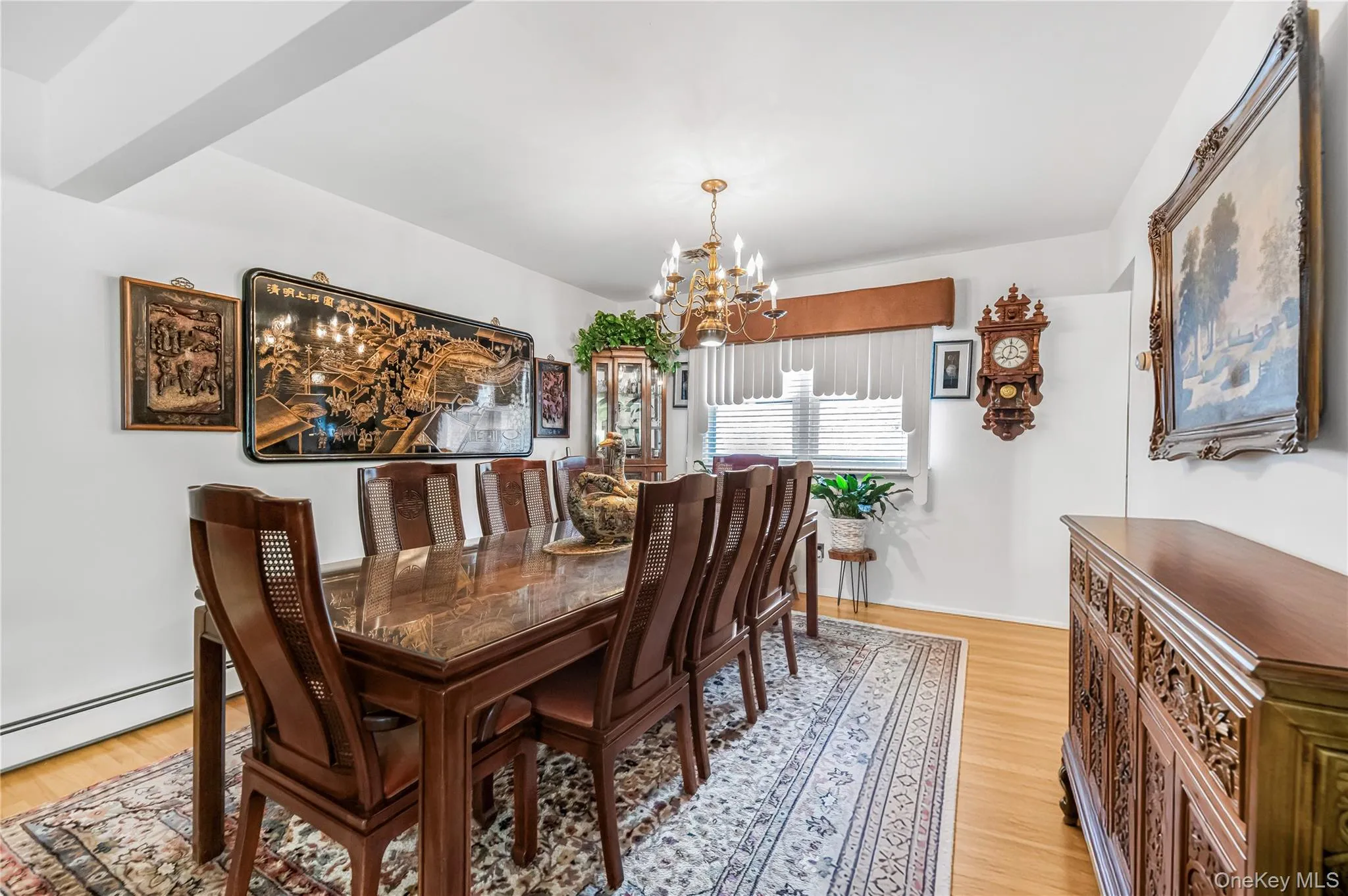 Hardwood flooring, chandelier lighting, white walls, and a built-in display cabinet Hardwood flooring, chandelier lighting, white walls, and a built-in display cabinet