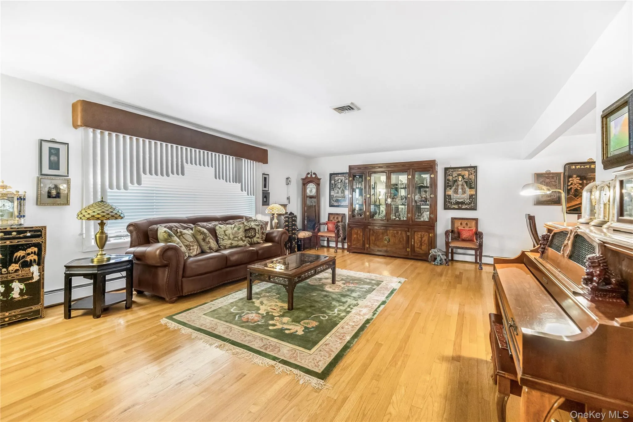 Light wood-finish flooring, white walls, and a multi-level floor plan with visible stairs Light wood-finish flooring, white walls, and a multi-level floor plan with visible stairs