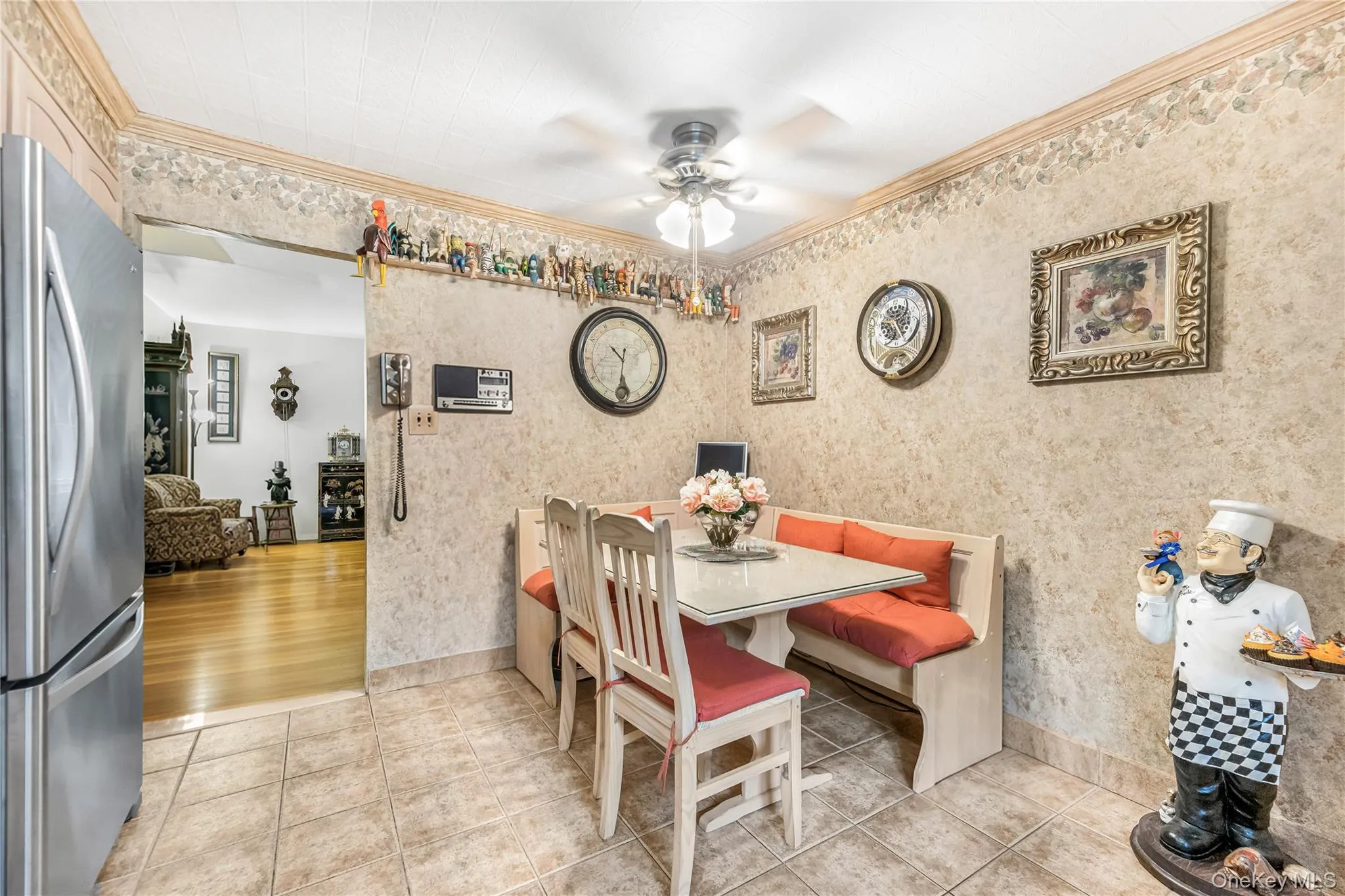 Kitchen featuring light-toned cabinetry, tile flooring, and stainless steel appliances Kitchen featuring light-toned cabinetry, tile flooring, and stainless steel appliances