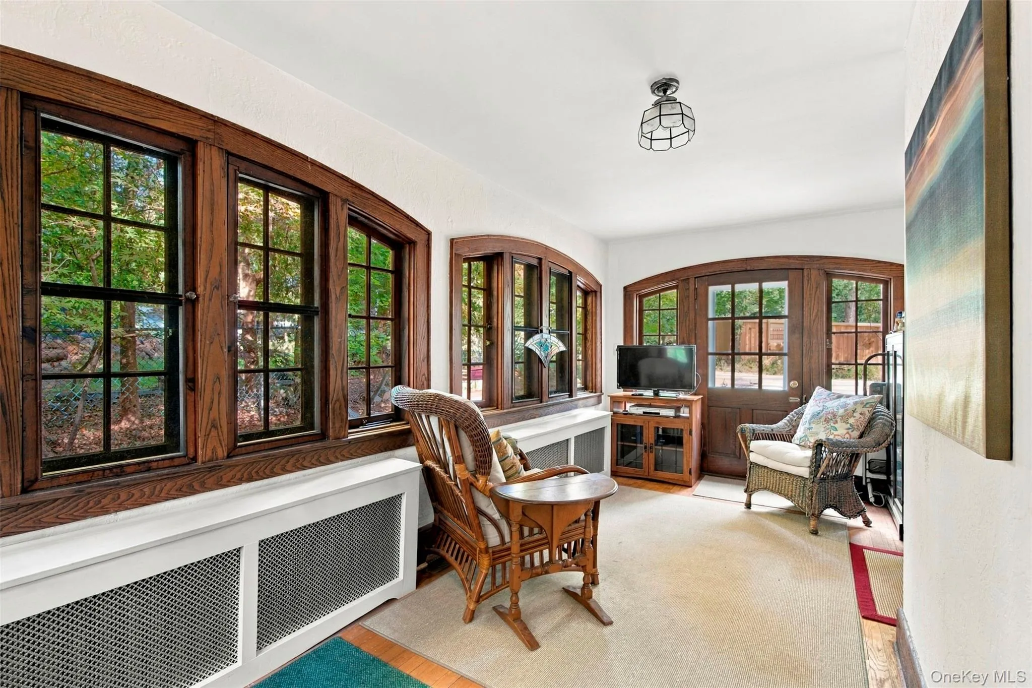 4-Season Sun Room with wall of arched windows and doorway. 4-Season Sun Room with wall of arched windows and doorway.