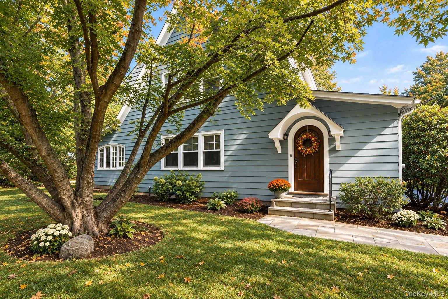 Classic Tudor-Revival hooded front entrance with arched oak door. Classic Tudor-Revival hooded front entrance with arched oak door.