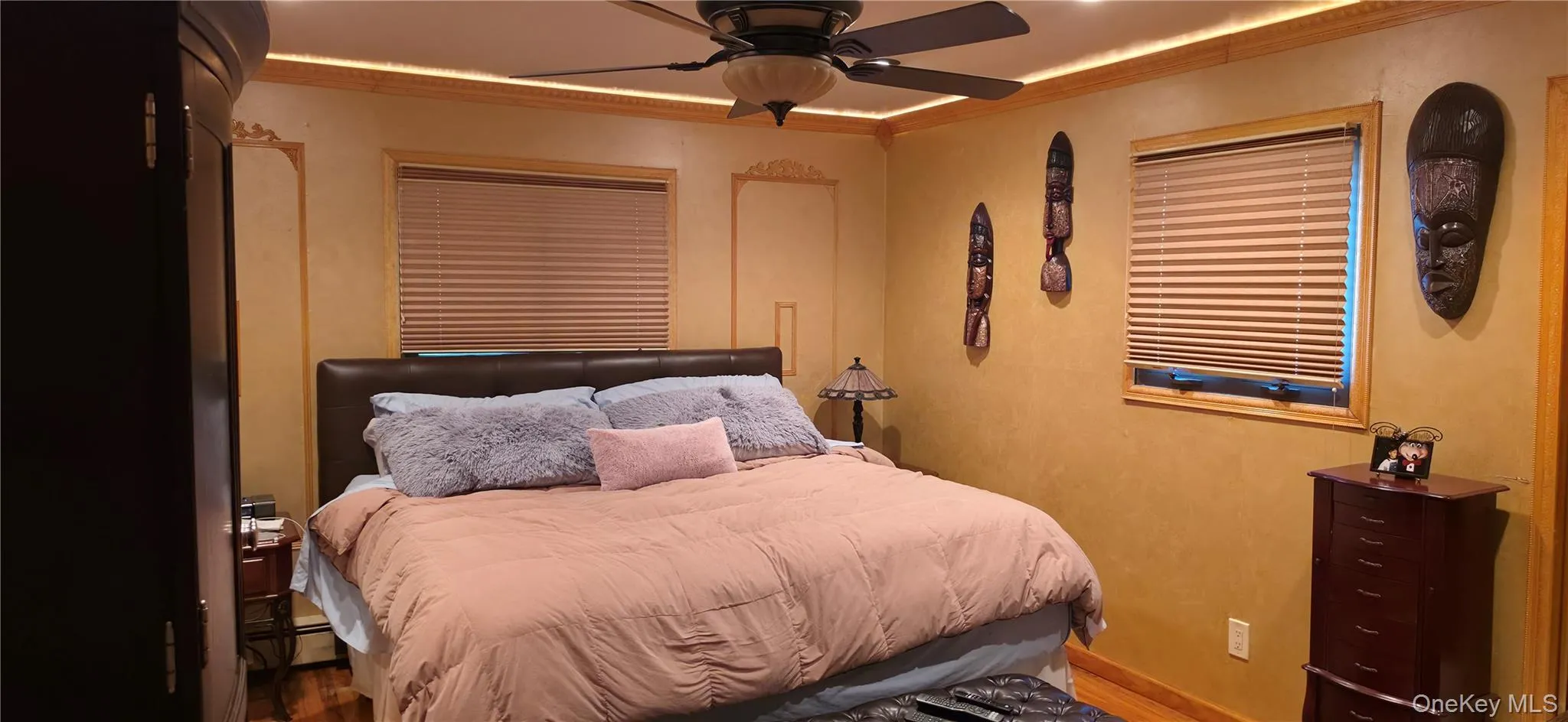 Recessed ceiling lighting, ceiling fan with integrated lighting, wood-finish flooring, two windows with blinds, and decorative wall molding Recessed ceiling lighting, ceiling fan with integrated lighting, wood-finish flooring, two windows with blinds, and decorative wall molding