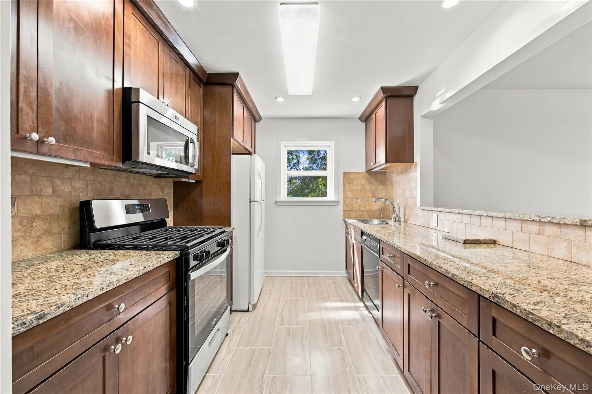 Galley-style kitchen open to living/dining space. Galley-style kitchen open to living/dining space.