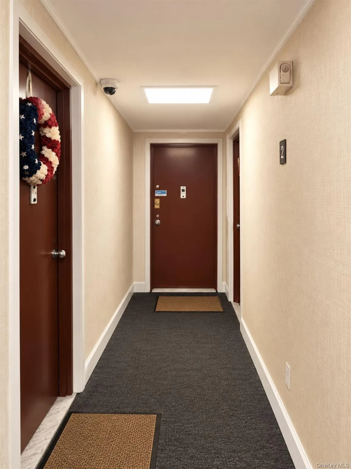 Textured wall covering with white trim, brown doors, and dark gray carpeted flooring Textured wall covering with white trim, brown doors, and dark gray carpeted flooring