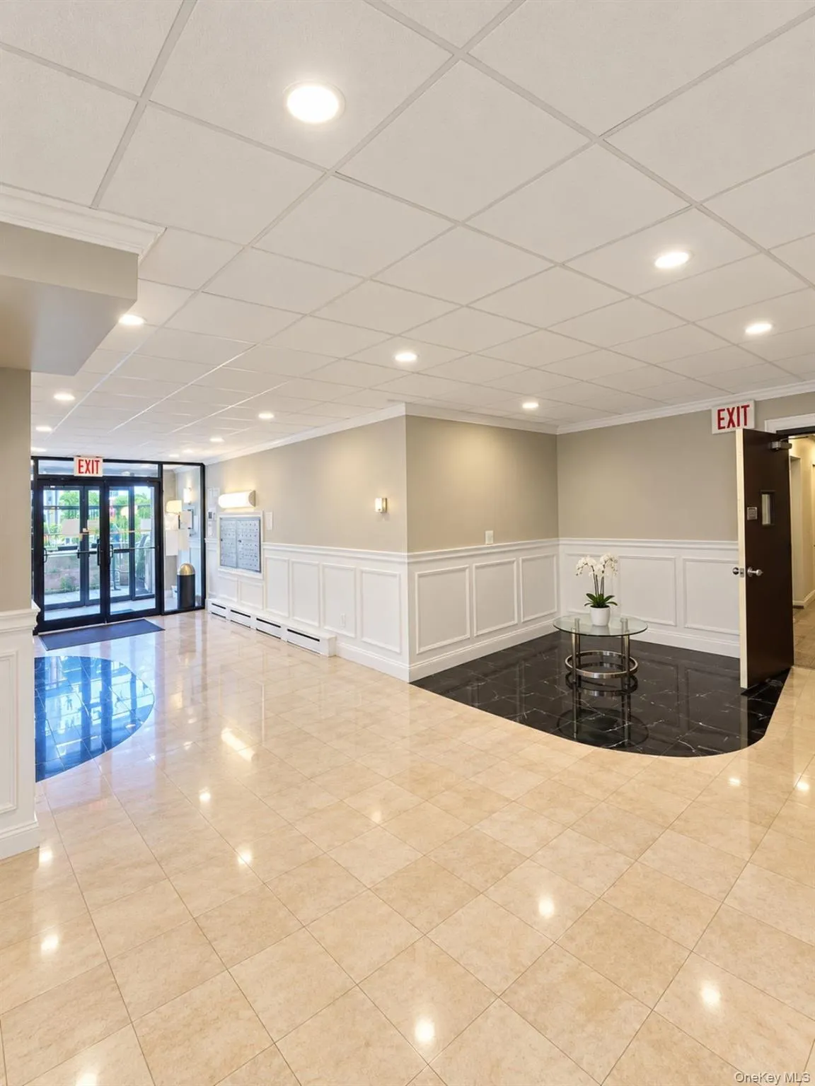 Recessed lighting illuminates the space, featuring wainscoting and crown molding Recessed lighting illuminates the space, featuring wainscoting and crown molding