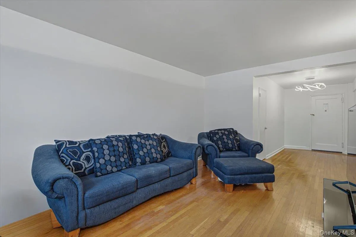 Hardwood flooring, coved ceilings, recessed lighting, and a modern ceiling fixture Hardwood flooring, coved ceilings, recessed lighting, and a modern ceiling fixture