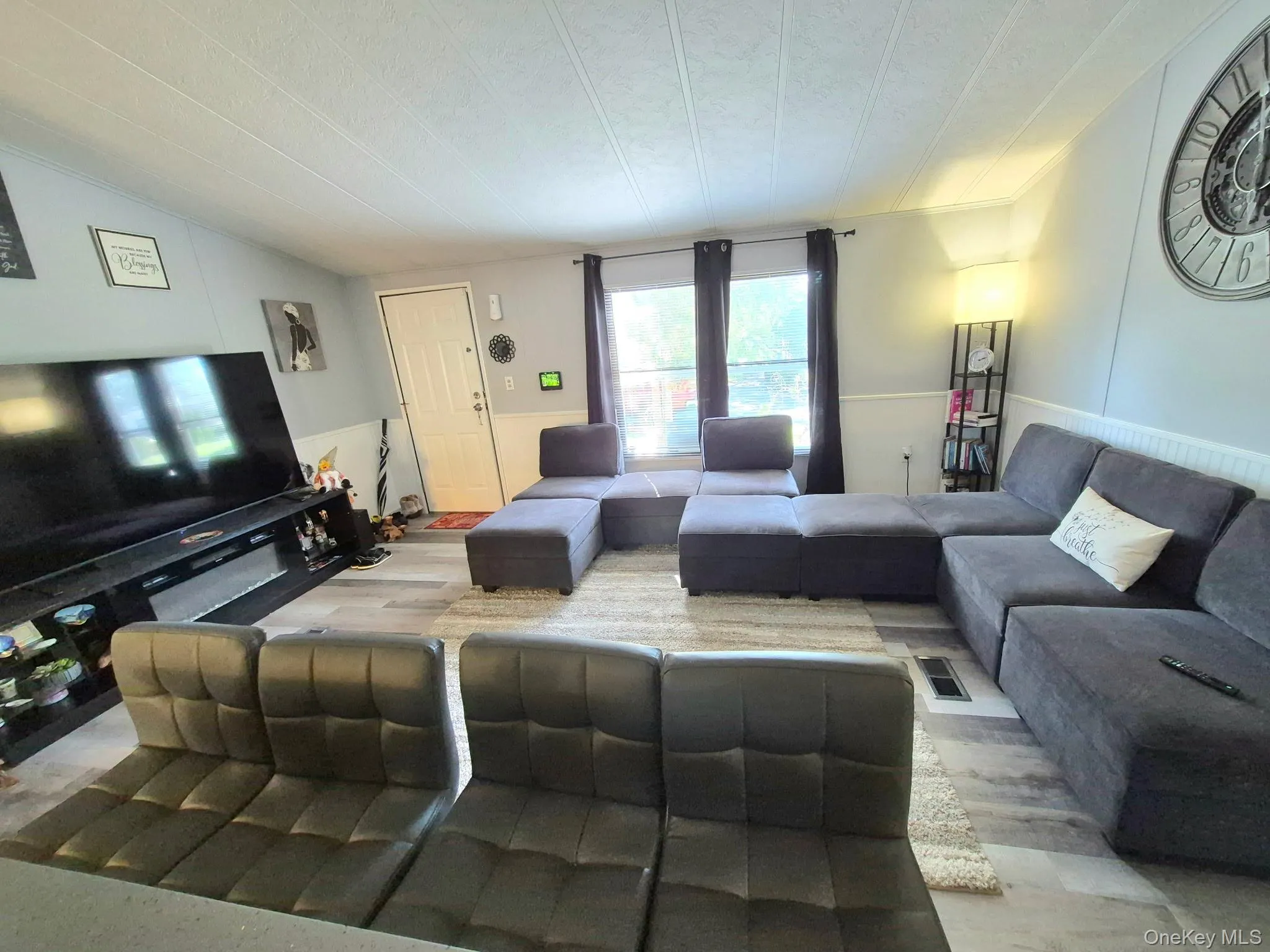 Light-toned wood-finish flooring, white paneled lower walls, and neutral wall color Light-toned wood-finish flooring, white paneled lower walls, and neutral wall color