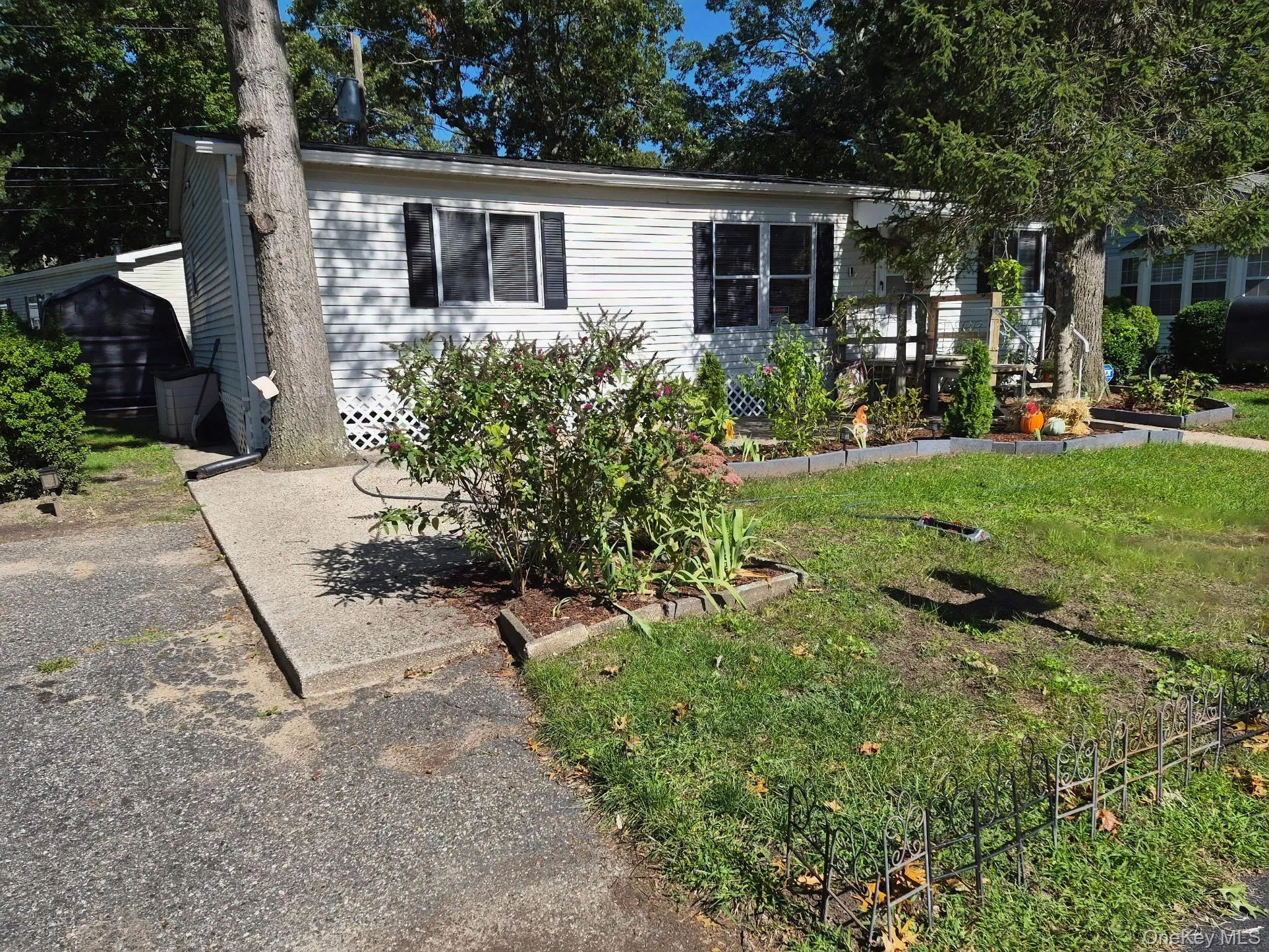White horizontal vinyl siding with black window shutters White horizontal vinyl siding with black window shutters