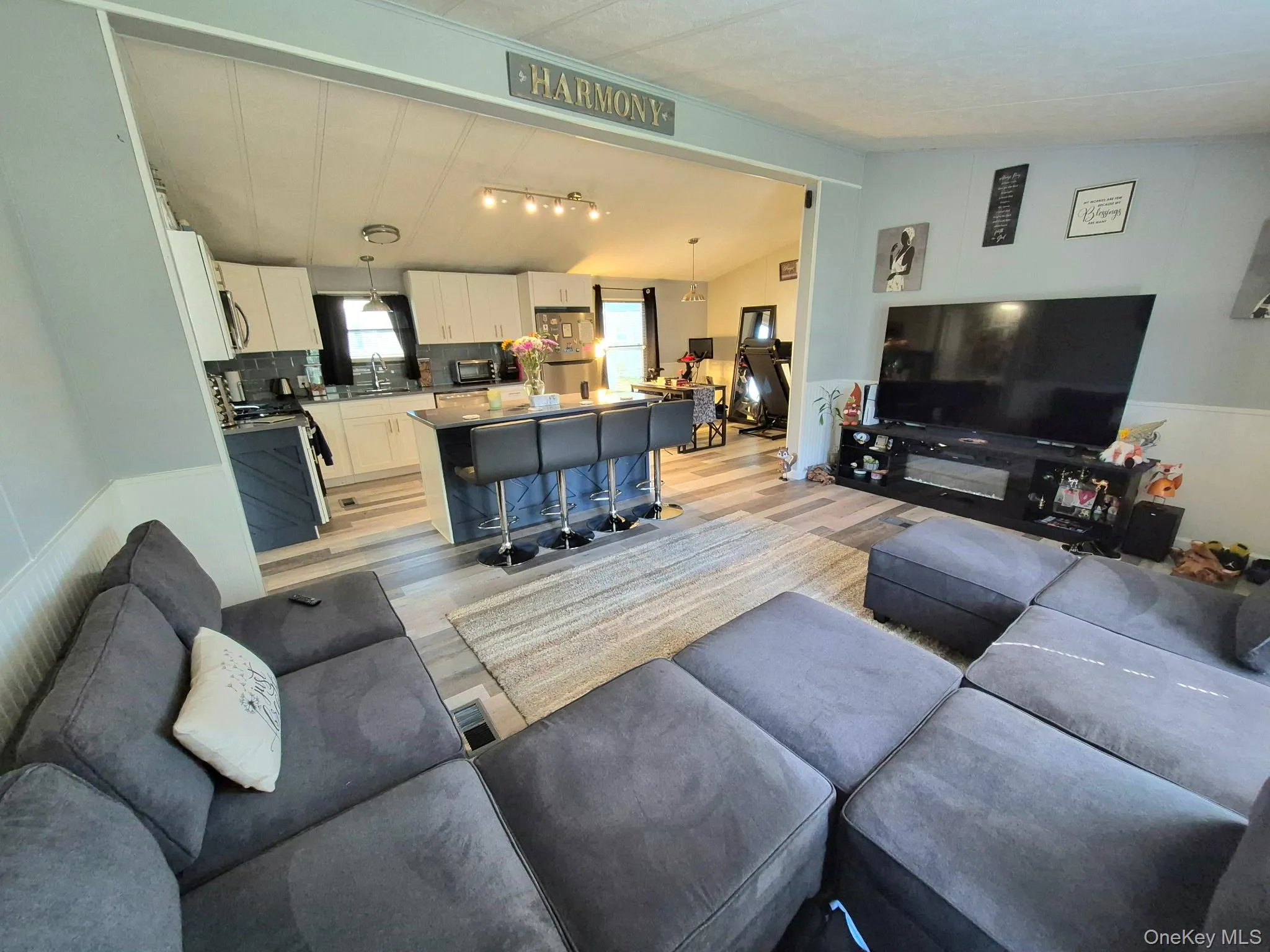 Open-concept living area with wood-finish flooring Open-concept living area with wood-finish flooring