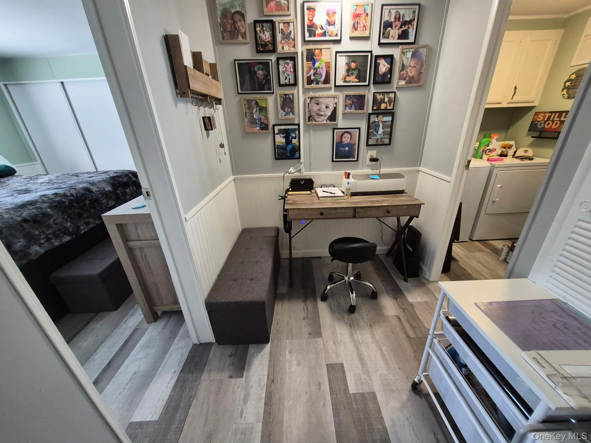 Wood-finish flooring throughout, beadboard wainscoting, and a built-in desk area Wood-finish flooring throughout, beadboard wainscoting, and a built-in desk area