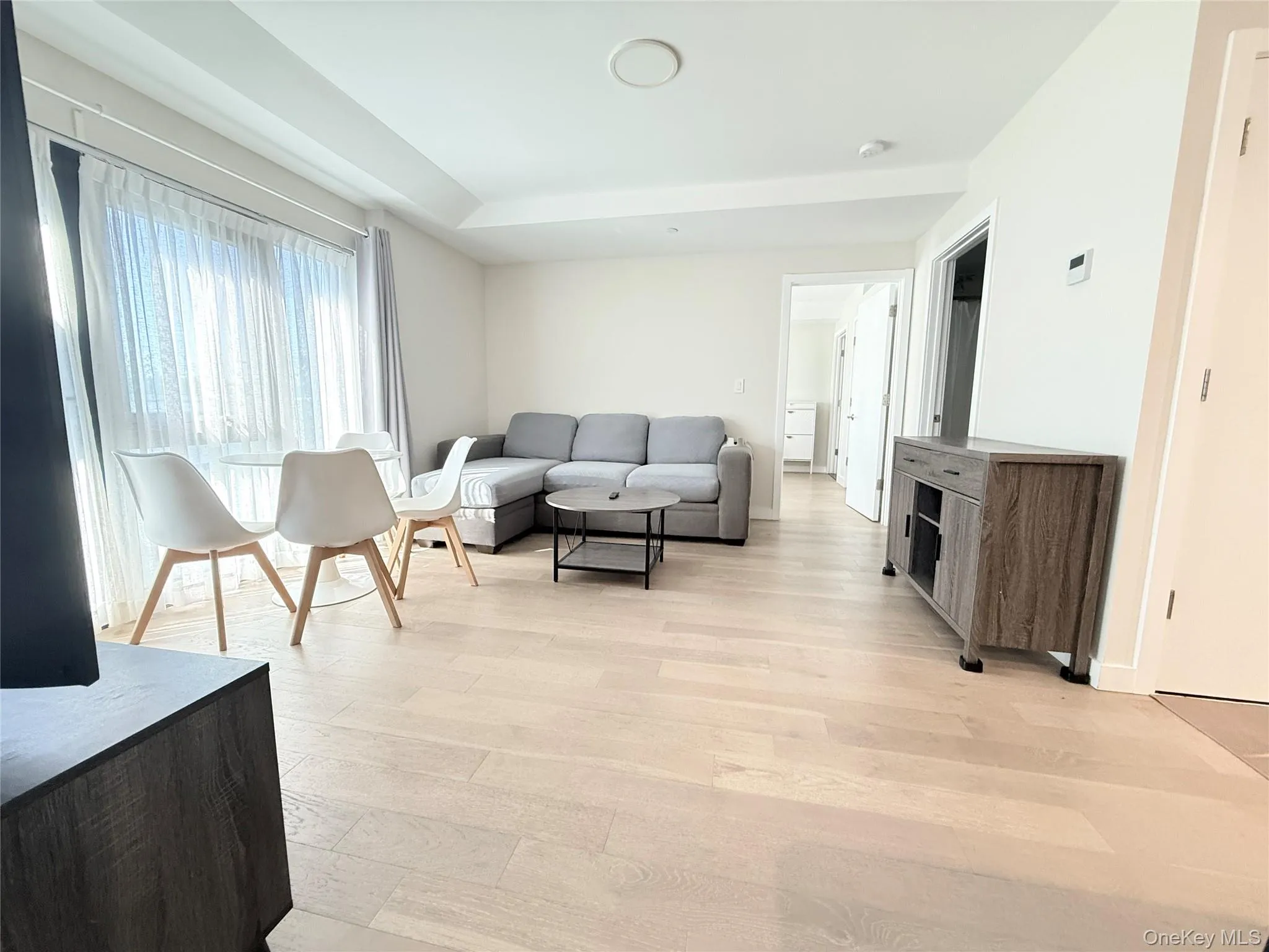 Recessed lighting, wood-finish flooring, and a tray ceiling create an inviting living space Recessed lighting, wood-finish flooring, and a tray ceiling create an inviting living space