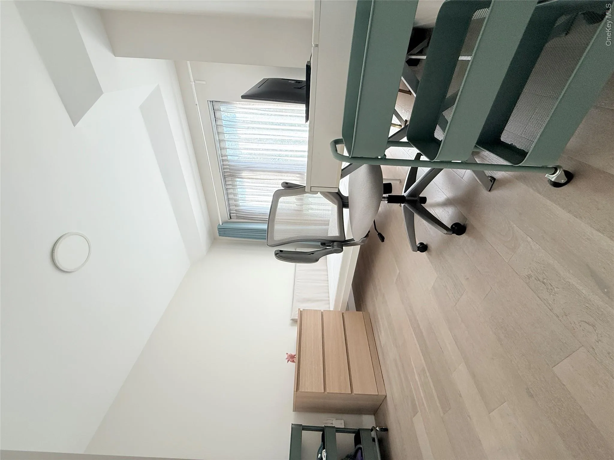 Recessed ceiling light, light wood-finish flooring, and window with sheer and blackout blinds Recessed ceiling light, light wood-finish flooring, and window with sheer and blackout blinds