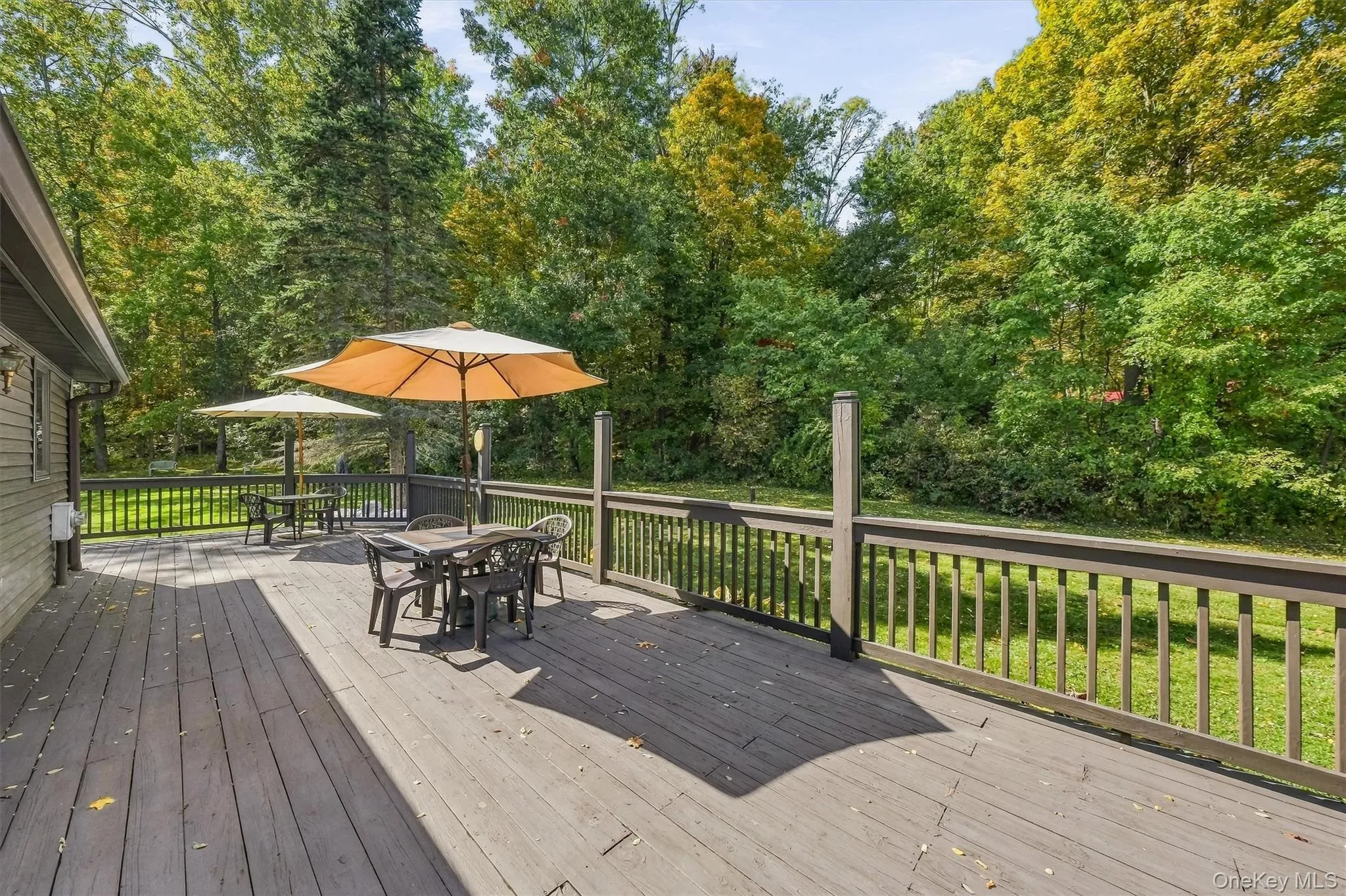 The back deck conveniently wraps around to the kitchen back door. The back deck conveniently wraps around to the kitchen back door.