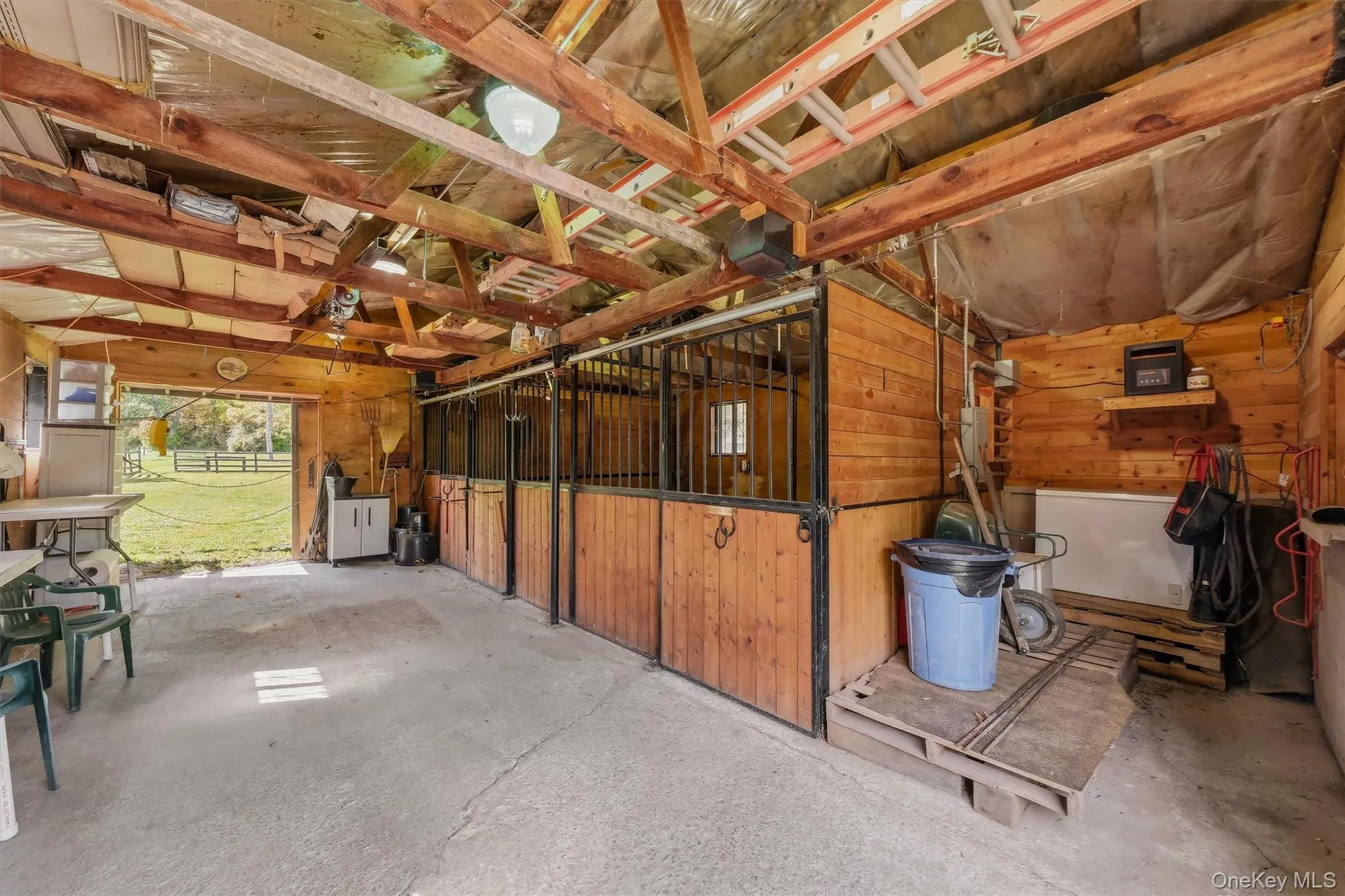 The barn includes 3 stalls, a tack/feed area, electric and a passage door. The barn includes 3 stalls, a tack/feed area, electric and a passage door.