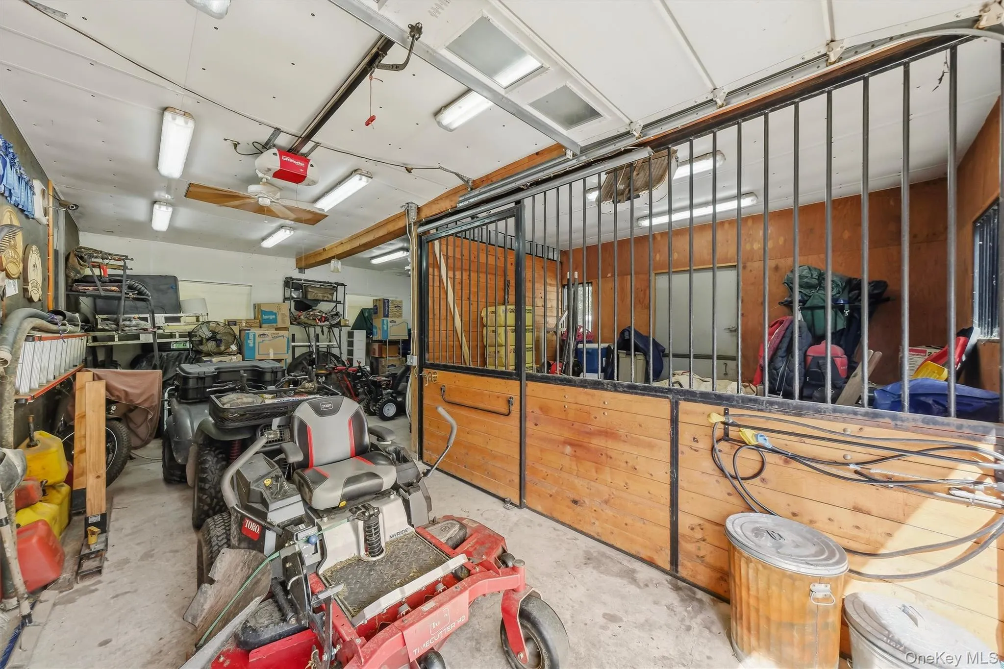 One bay is dedicated to an additional stall and a wash stall, and is separate from the rest of the garage. The stall has a dutch door to the outside, providing the setup for a run-out. One bay is dedicated to an additional stall and a wash stall, and is separate from the rest of the garage. The stall has a dutch door to the outside, providing the setup for a run-out.