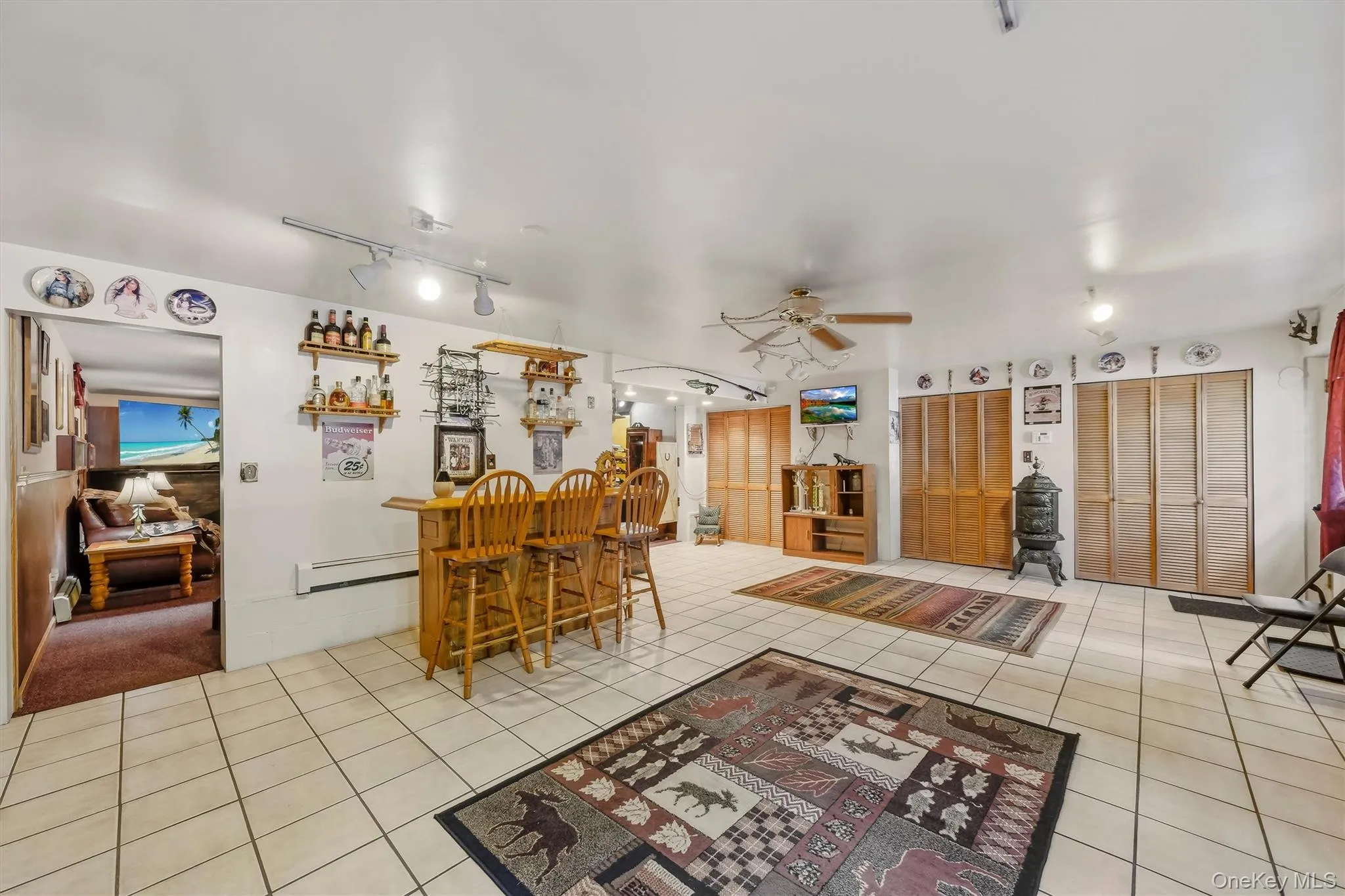 The finished basement features 2 rooms, one a gathering room and the other a bar/play area with tiled floor and an entrance to the driveway. The finished basement features 2 rooms, one a gathering room and the other a bar/play area with tiled floor and an entrance to the driveway.
