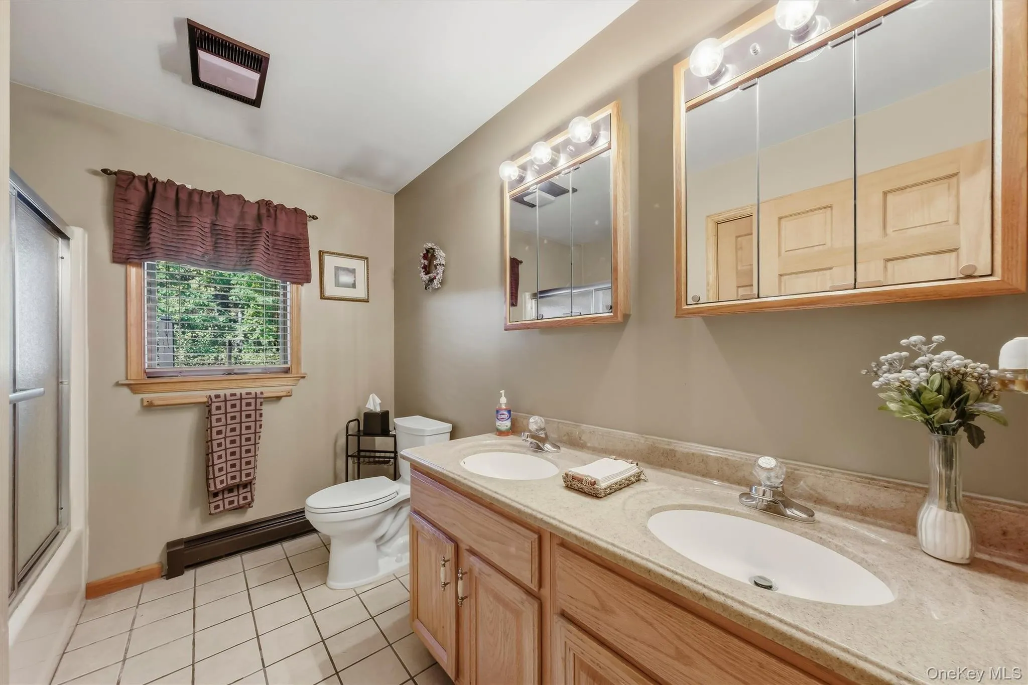 The main bathroom on the first floor is quite spacious and enjoys double sinks, double cabinets, an in-room linen closet and tile floors. The main bathroom on the first floor is quite spacious and enjoys double sinks, double cabinets, an in-room linen closet and tile floors.