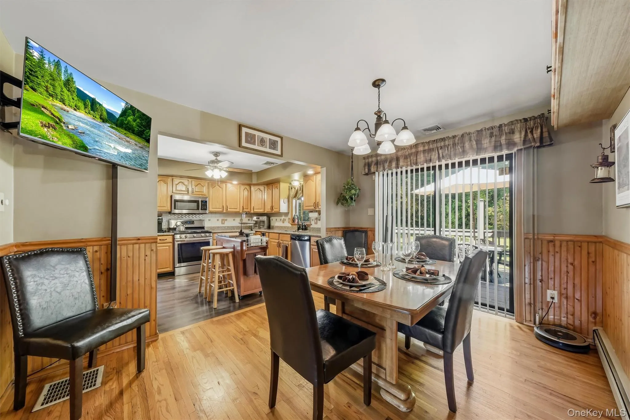 Wainscoting, hardwood floors, and sliders to the deck are a few great features of the dining room. Wainscoting, hardwood floors, and sliders to the deck are a few great features of the dining room.