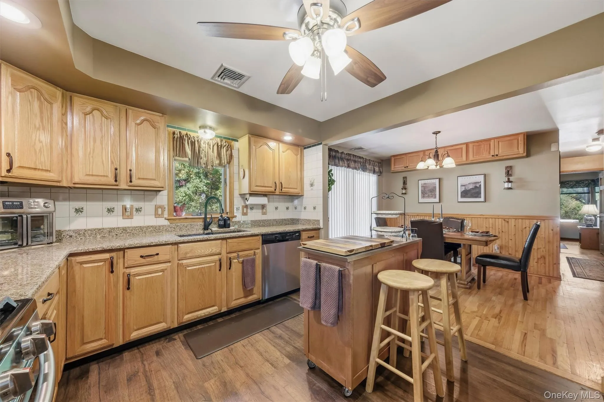 An open floor plan between the kitchen and dining room makes serving a meal a breeze. An open floor plan between the kitchen and dining room makes serving a meal a breeze.