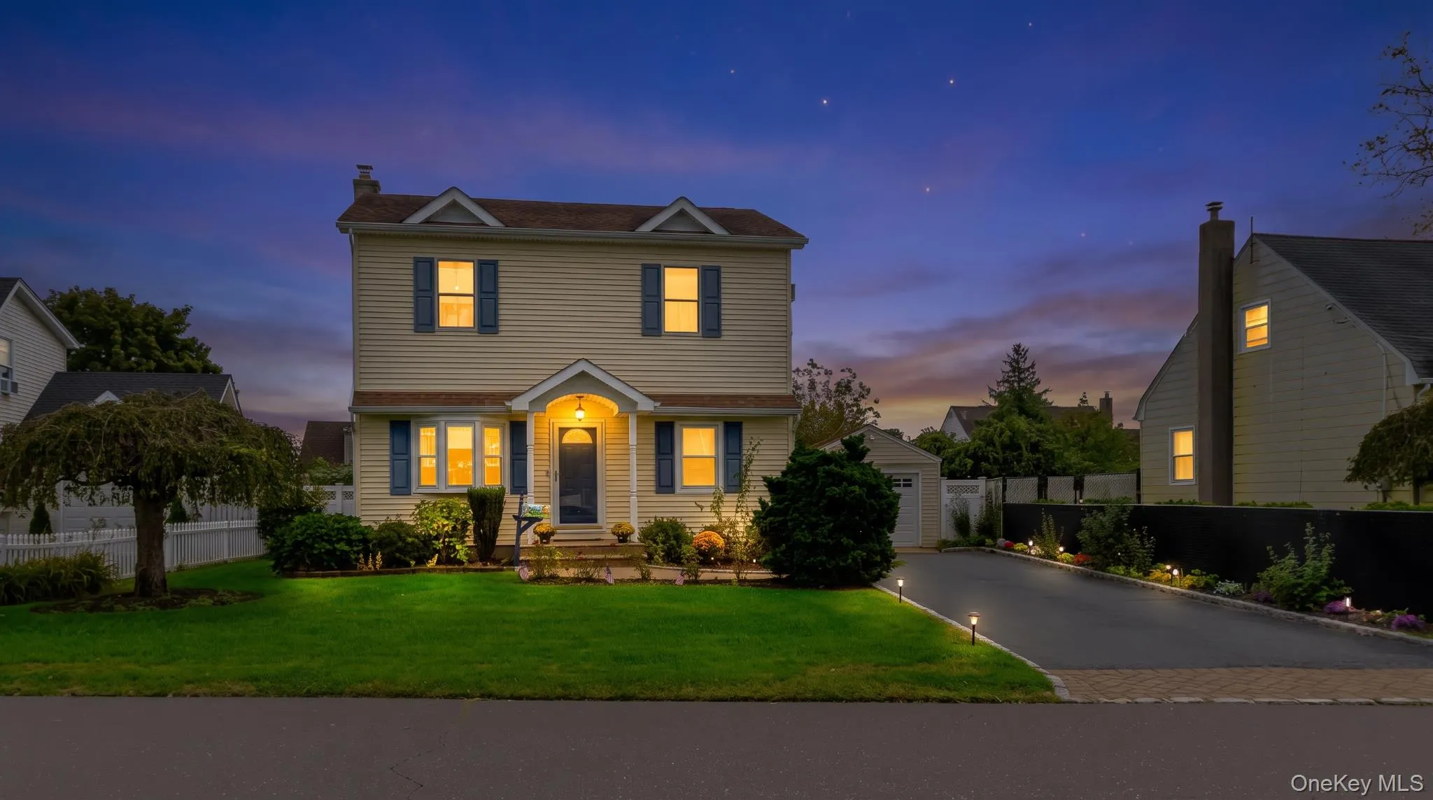 Two-story residence featuring siding exterior, an arched entry, and blue window shutters Two-story residence featuring siding exterior, an arched entry, and blue window shutters
