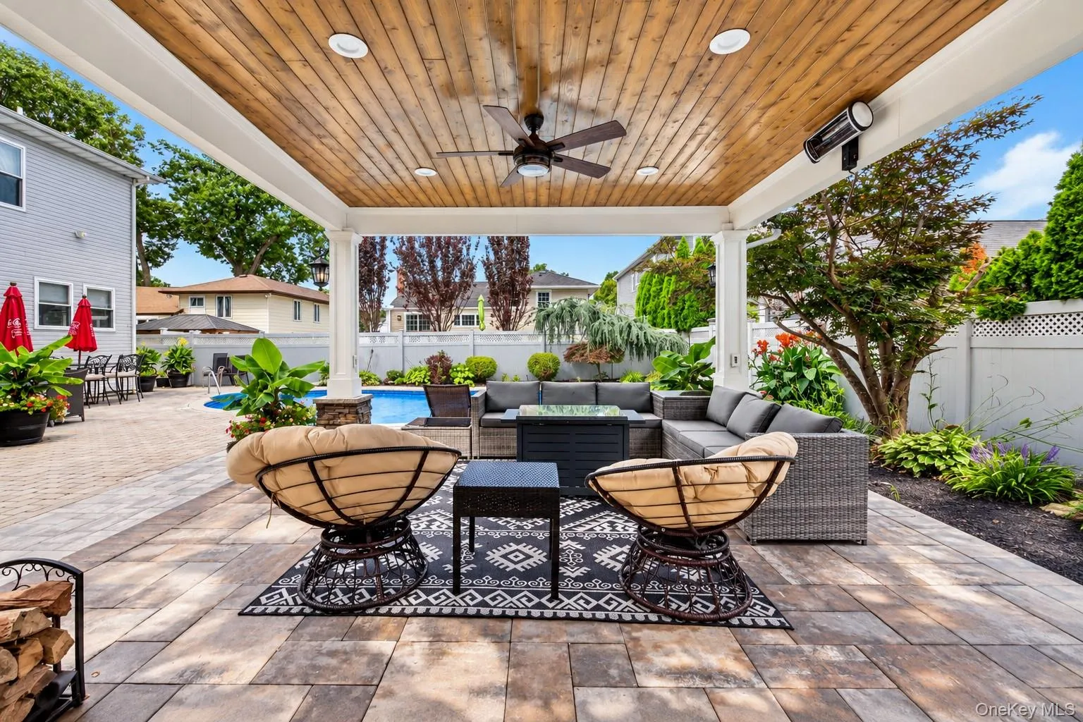 Covered patio with a wood-finish ceiling, recessed lighting, and a ceiling fan Covered patio with a wood-finish ceiling, recessed lighting, and a ceiling fan