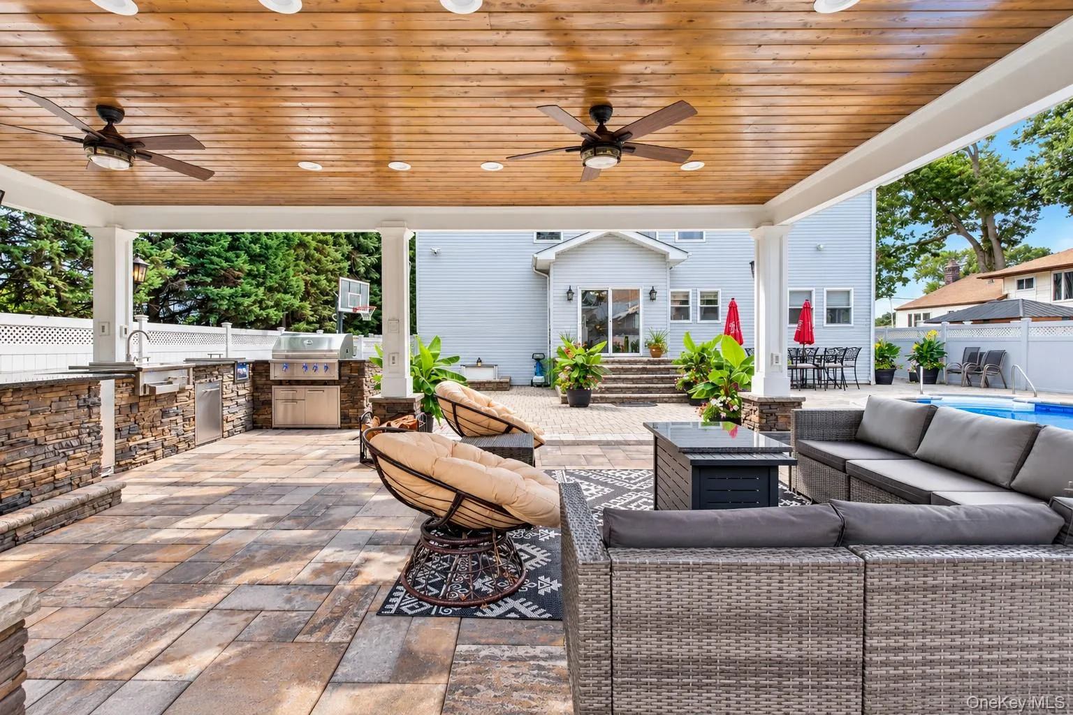 Covered patio featuring a wood-finish ceiling, recessed lighting, and ceiling fans Covered patio featuring a wood-finish ceiling, recessed lighting, and ceiling fans