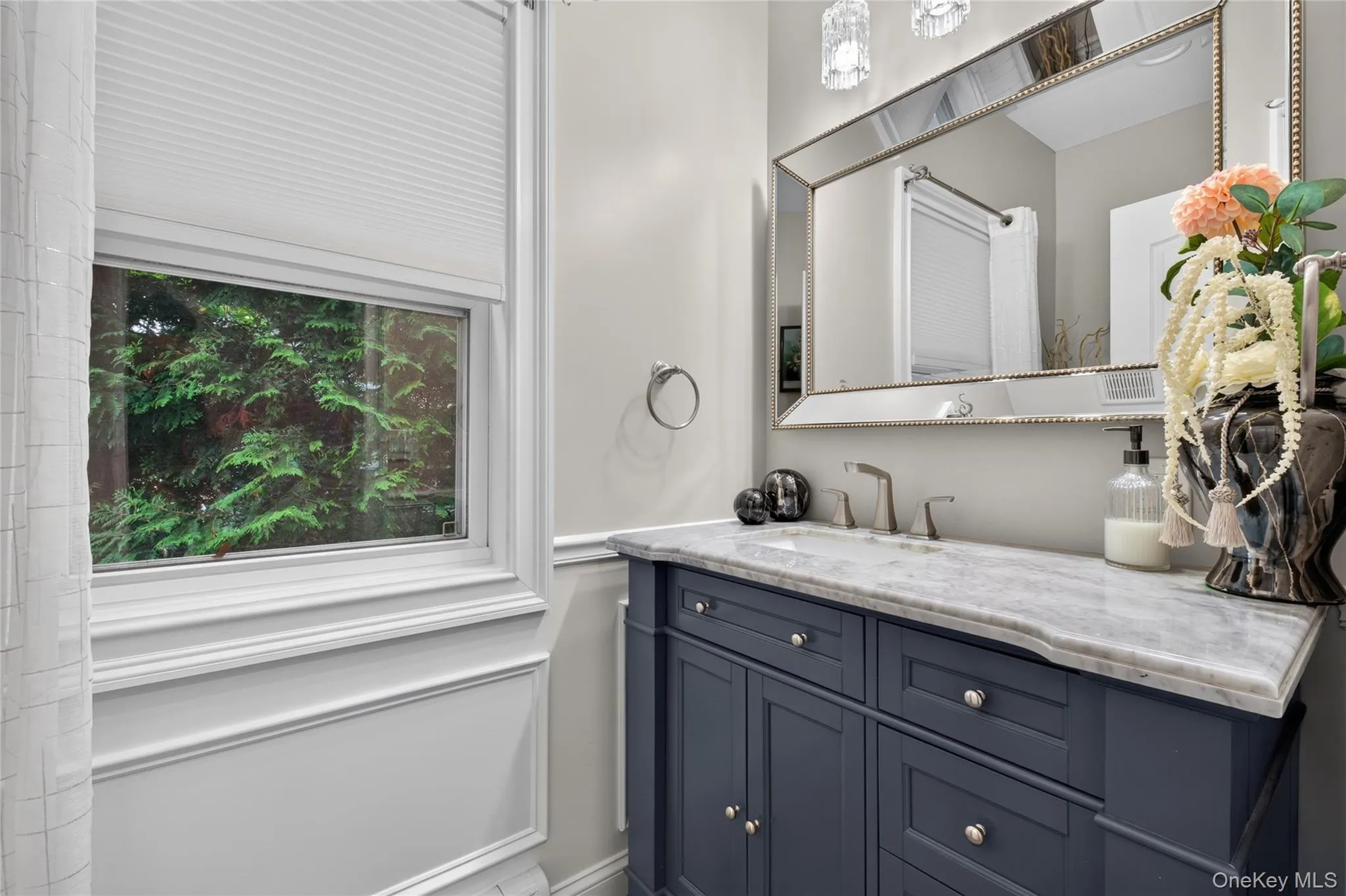 Bathroom vanity with a stone countertop, undermount sink, and brushed nickel faucet Bathroom vanity with a stone countertop, undermount sink, and brushed nickel faucet