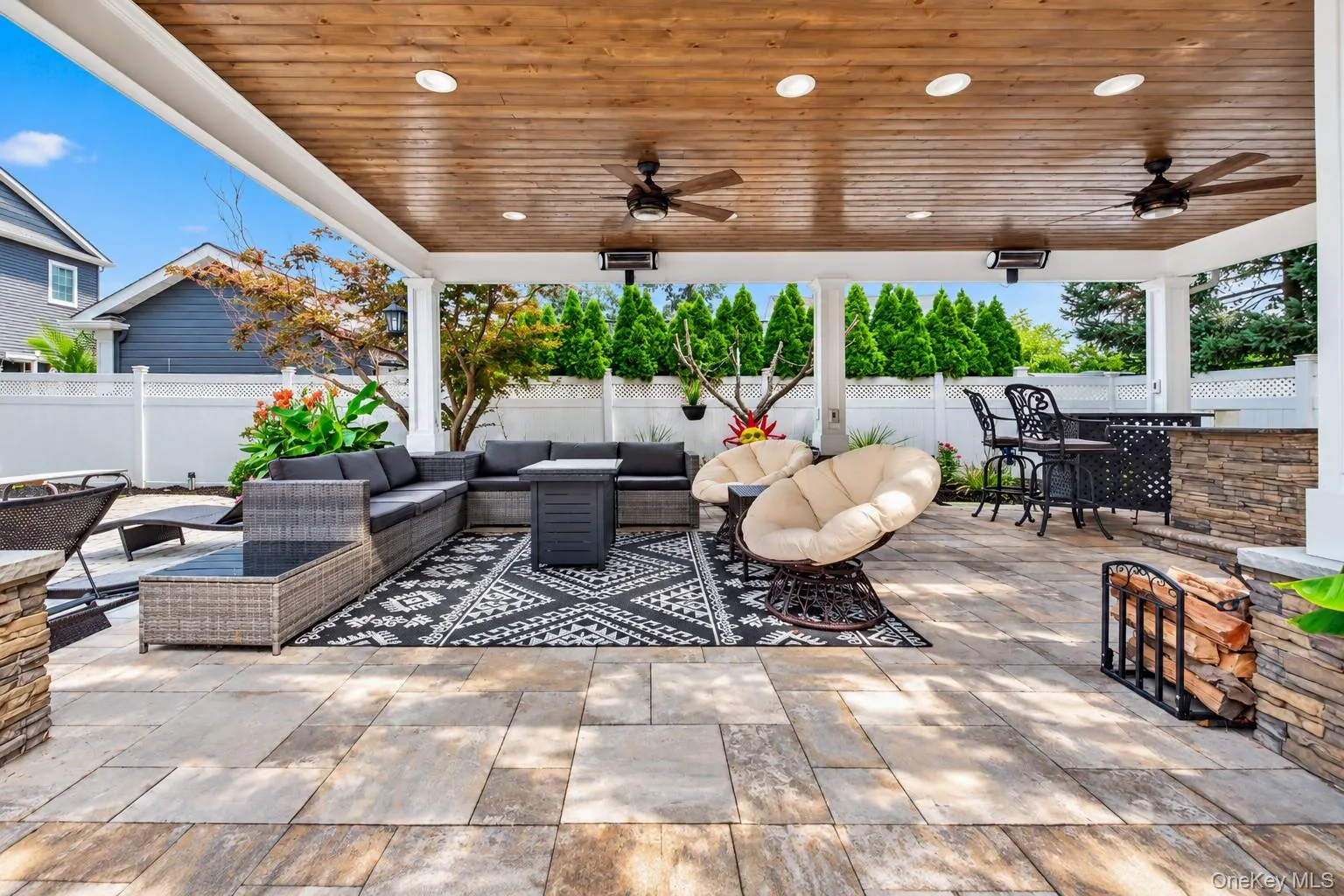 Covered patio with a wood-finish ceiling, recessed lighting, and ceiling fans Covered patio with a wood-finish ceiling, recessed lighting, and ceiling fans