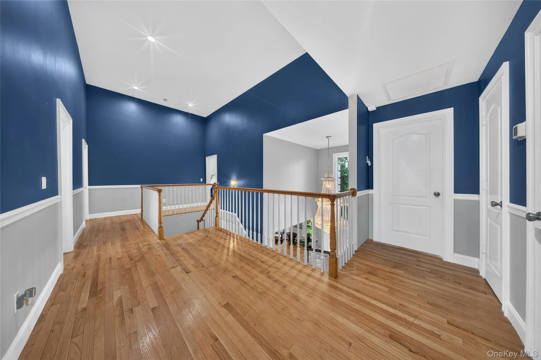 Hardwood flooring, painted accent walls, white trim, recessed lighting, and white panel doors Hardwood flooring, painted accent walls, white trim, recessed lighting, and white panel doors