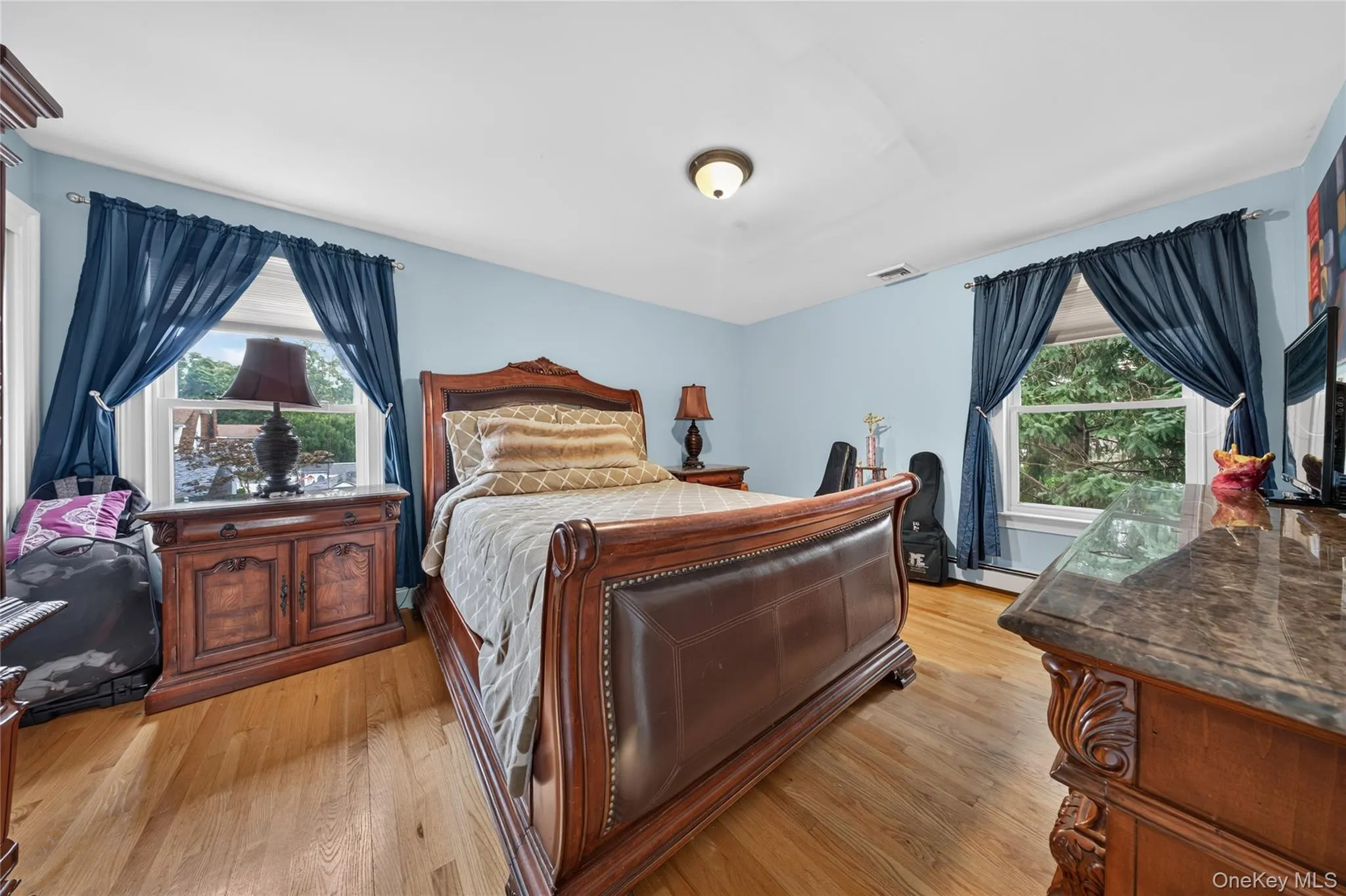 Wood-finish flooring with light blue walls and white trim Wood-finish flooring with light blue walls and white trim
