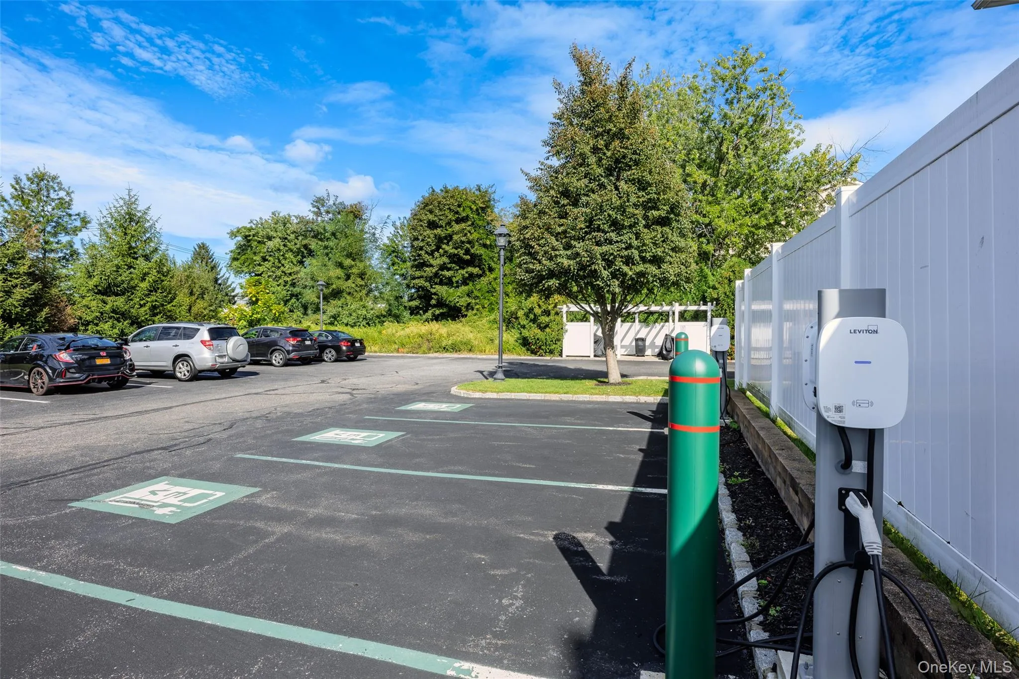 Outdoor Parking Area Featuring Designated Electric Vehicle Charging Stations Outdoor Parking Area Featuring Designated Electric Vehicle Charging Stations