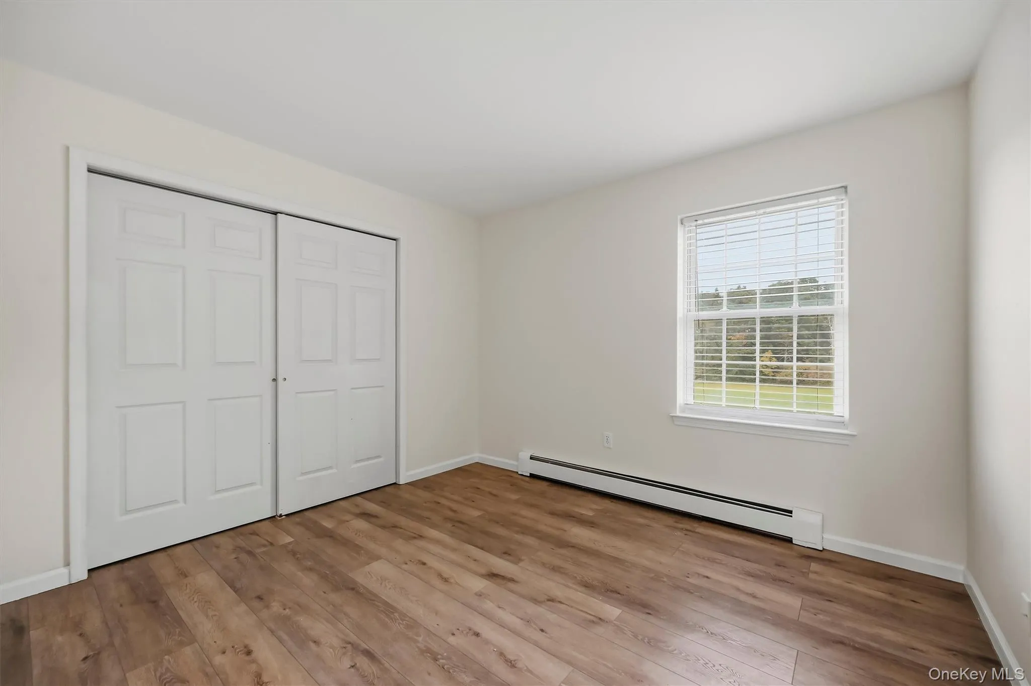Third bedroom with warm flooring and a full wall of closet space. Third bedroom with warm flooring and a full wall of closet space.