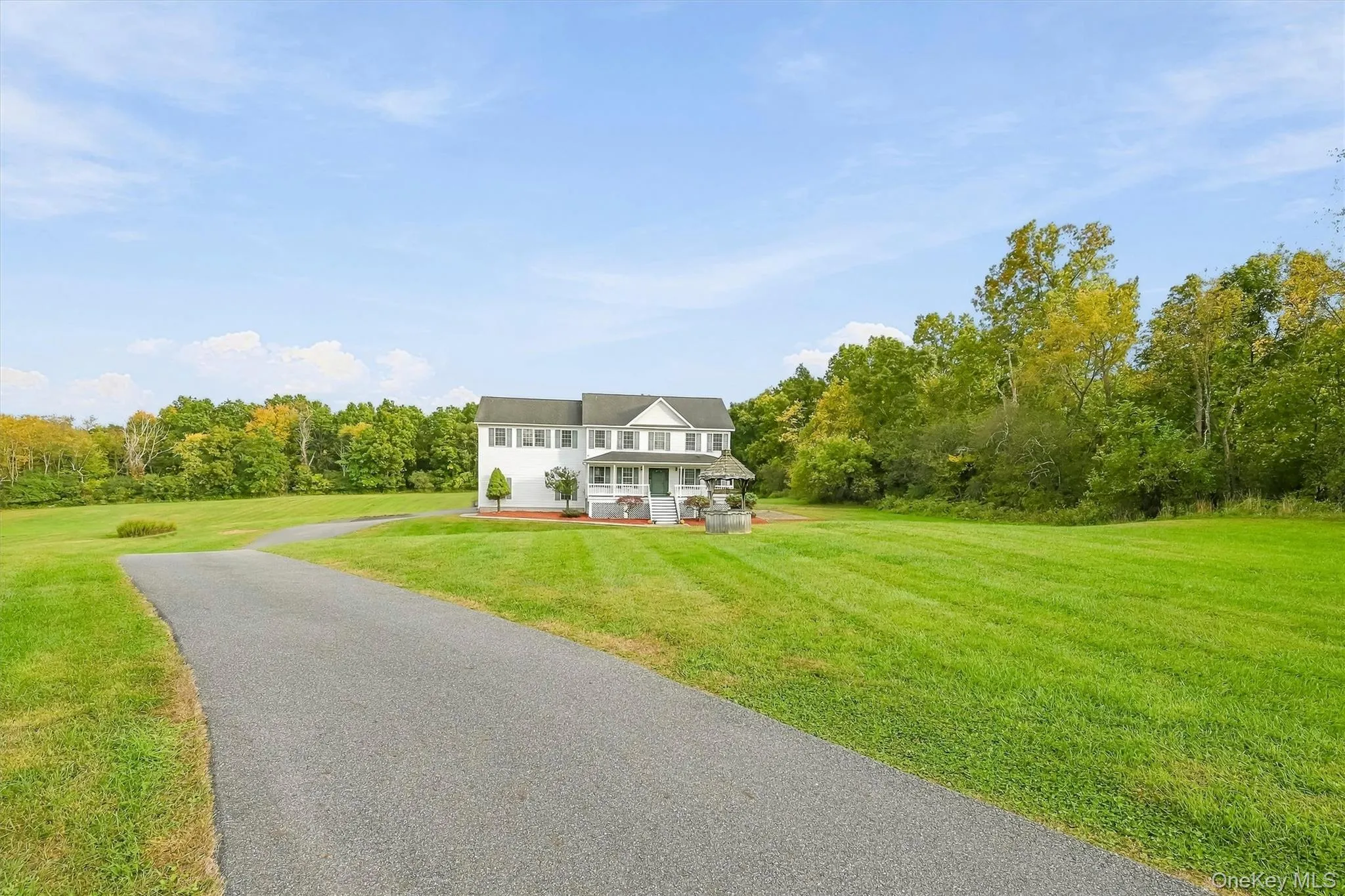 A long, sweeping driveway creates an impressive approach while setting the home comfortably back from the road. A long, sweeping driveway creates an impressive approach while setting the home comfortably back from the road.