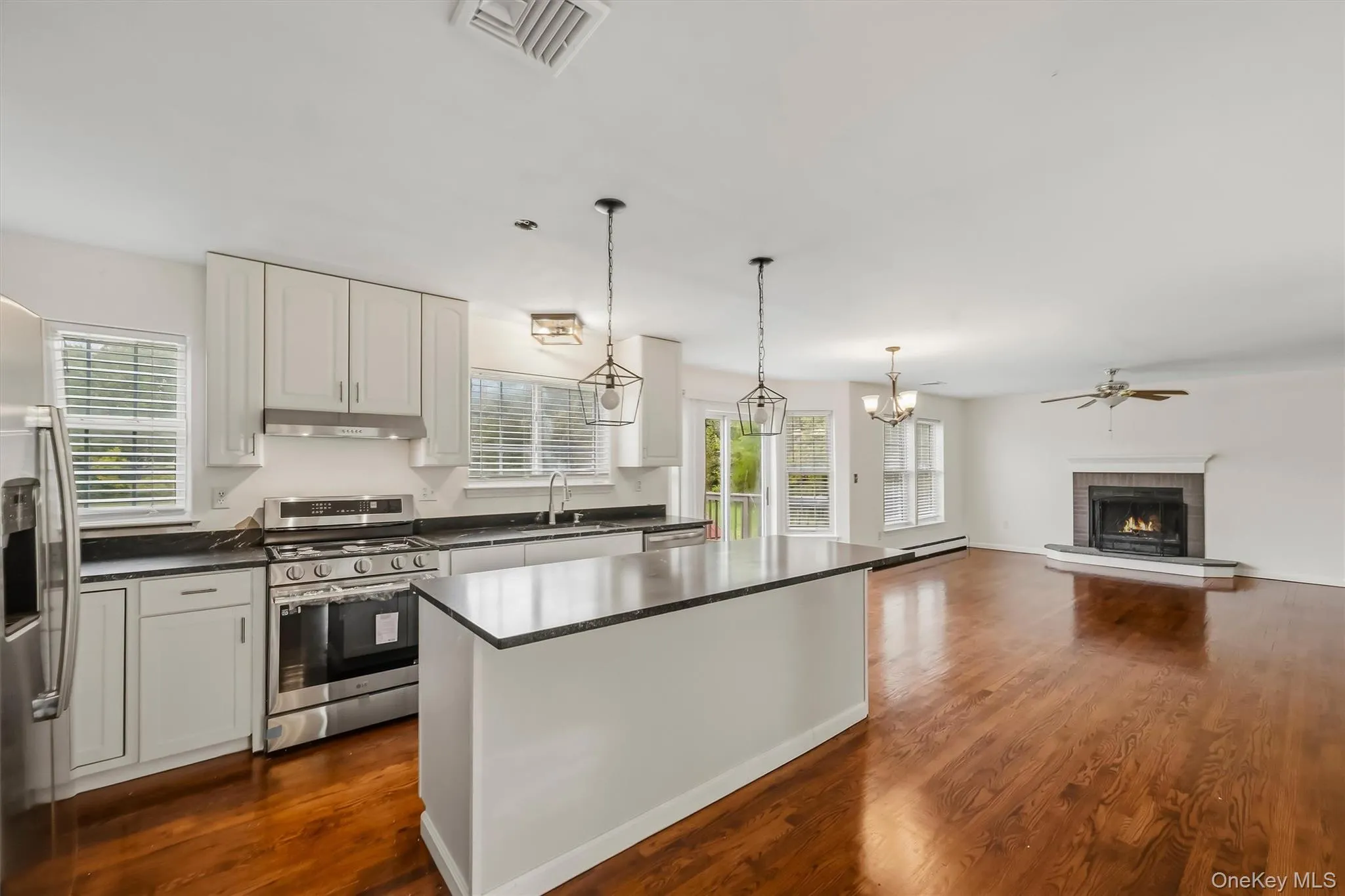 Recently updated kitchen featuring refreshed cabinetry, countertops, stainless steel appliances, and a large center island. Recently updated kitchen featuring refreshed cabinetry, countertops, stainless steel appliances, and a large center island.