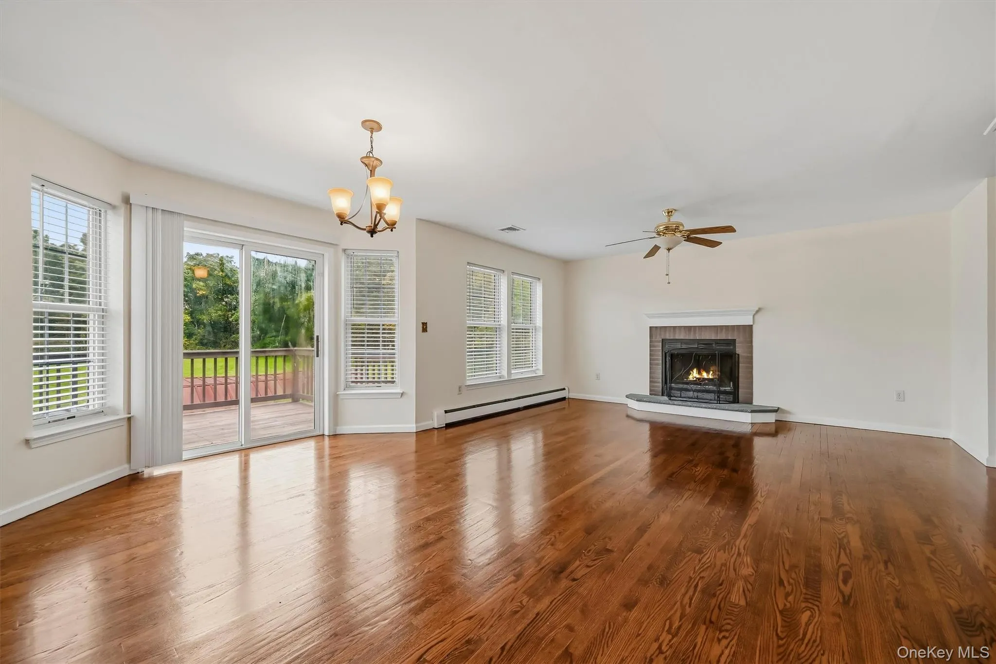 A wall of windows, rich hardwood floors, and a fireplace make this living space one of the home’s standout rooms. A wall of windows, rich hardwood floors, and a fireplace make this living space one of the home’s standout rooms.